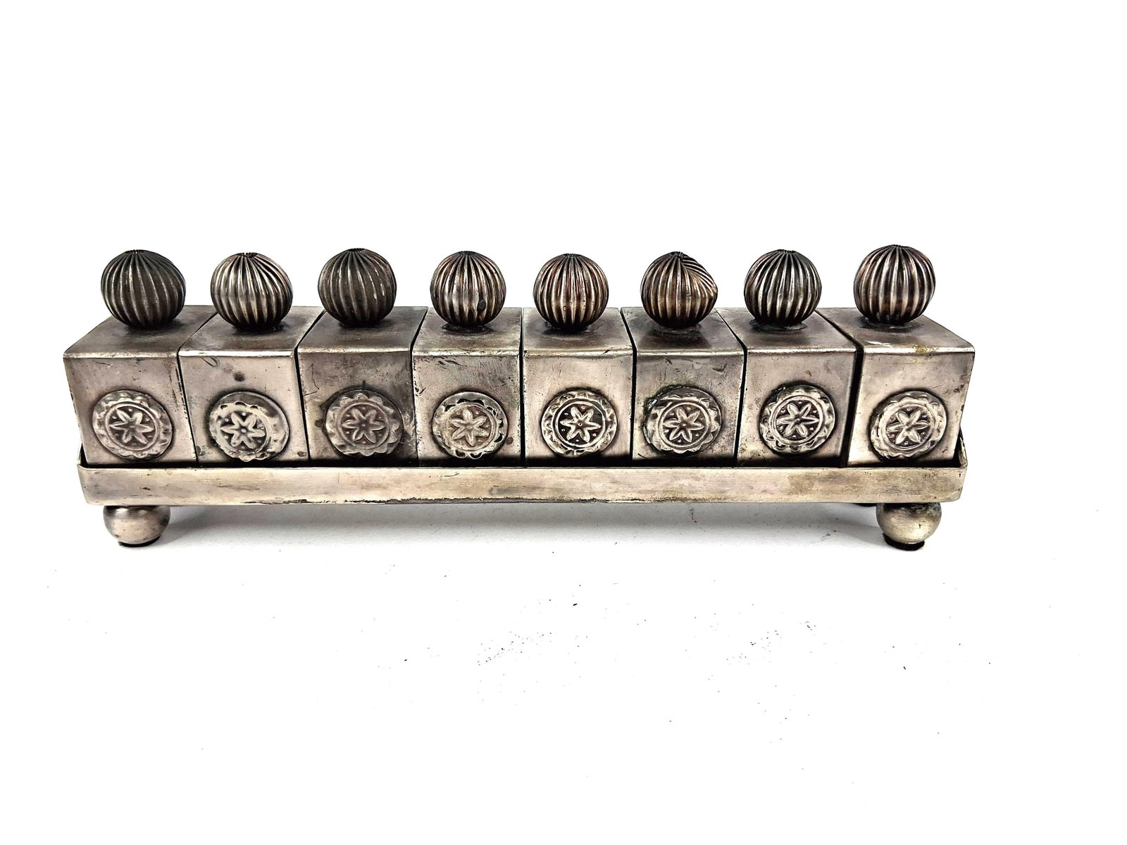 Silver Tone Napkin Rings in Fitted Tray: A set of modular napkin rings presented in a coordinating rectangular tray, crafted from silver-toned metal. The tray is supported by four ball feet and features a low gallery with a rounded end