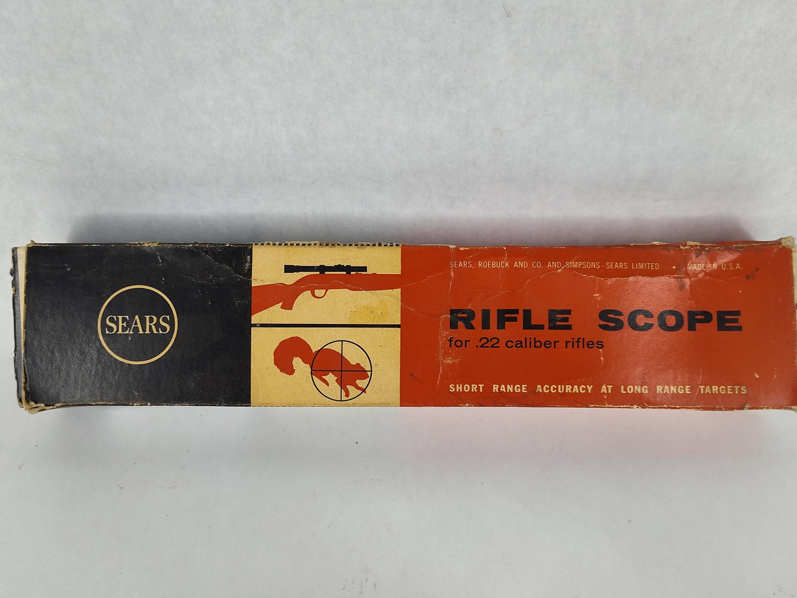 Sears .22 Caliber Rifle Scope: This lot features a Sears rifle scope designed for .22 caliber rifles, presented in its original retail box. The scope is finished in a blued black and is equipped with translucent plastic lens caps
