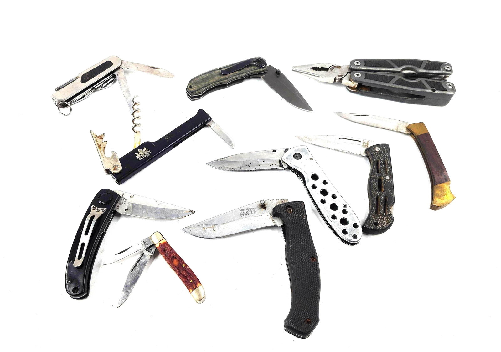10 Schrade & Frost Knives & Multi-Tools: An assortment of ten folding knives and multi-tools designed for utility and sporting applications. The collection includes a Schrade pliers-based multi-tool featuring needle-nose pliers, wire cutters