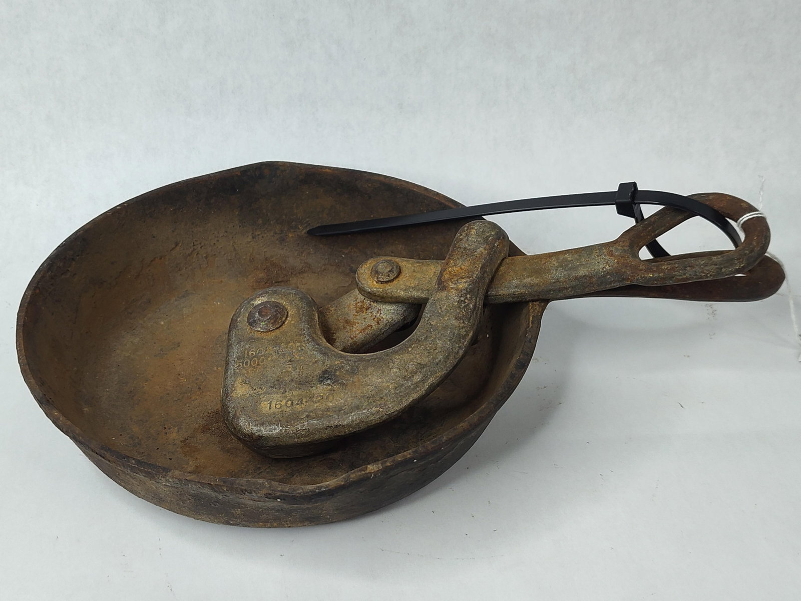 Lodge Cast Iron Skillet & Klein Grip: This lot contains two American-made metal items: a cast iron skillet and an industrial wire grip tool. The first item is a Lodge Manufacturing Co. cast iron skillet featuring dual pour spouts and a ha