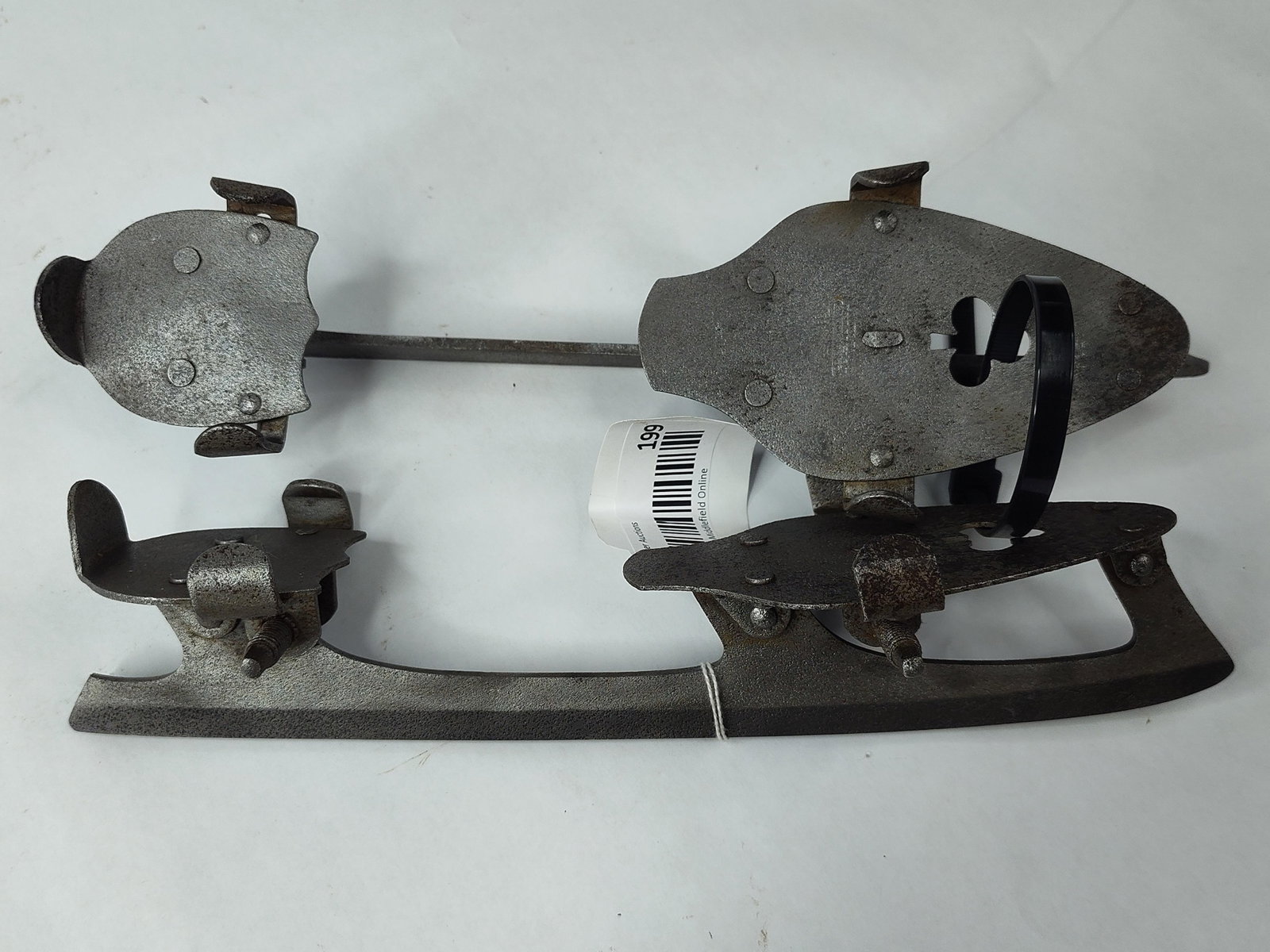 Pair Union Hardware Steel Ice Skates: A pair of antique all-metal ice skates manufactured by Union Hardware Co. of Torrington, Connecticut. These skates feature a forged steel construction with an adjustable clamp system designed for
