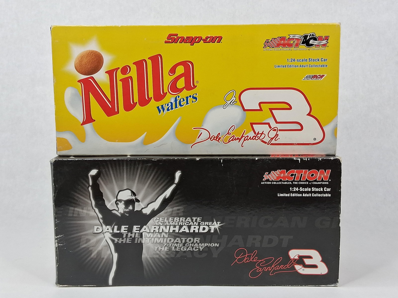 Action Earnhardt & Jr. NASCAR Models: A lot of two 1:24 scale die-cast NASCAR stock cars manufactured by Action Racing Collectables. The first model is a 2002 Dale Earnhardt Jr. #3 Chevrolet Monte Carlo featuring a multi-brand Nabisco