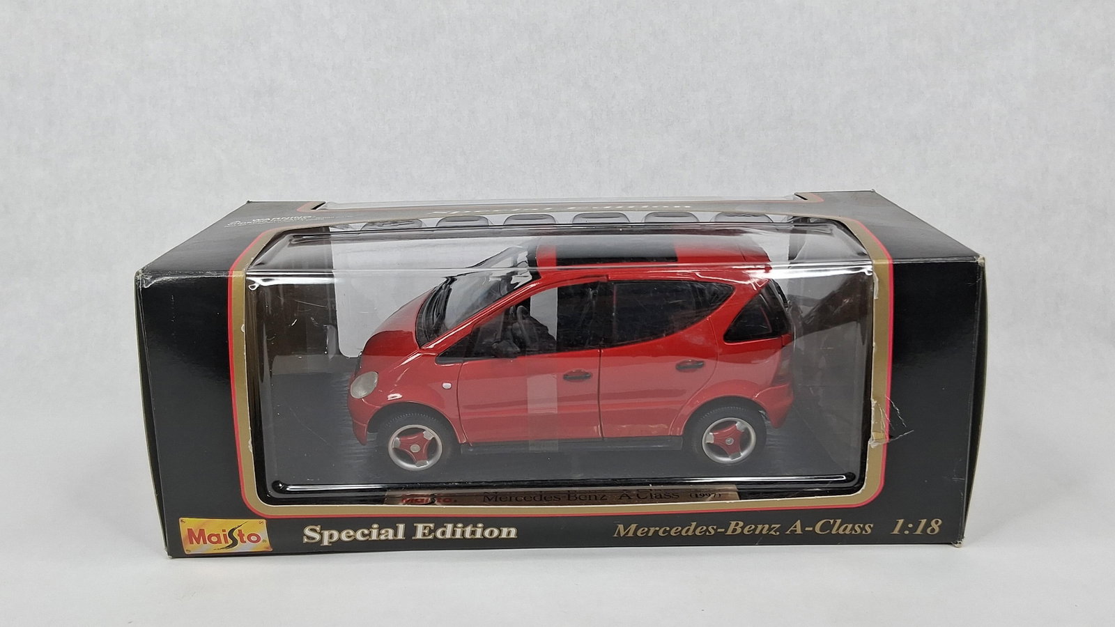 Maisto 1:18 1997 Mercedes-Benz A-Class: A Maisto Special Edition 1:18 scale die-cast model car depicting a 1997 Mercedes-Benz A-Class. The vehicle is finished in red with a dark interior and is constructed from die-cast metal with plastic c