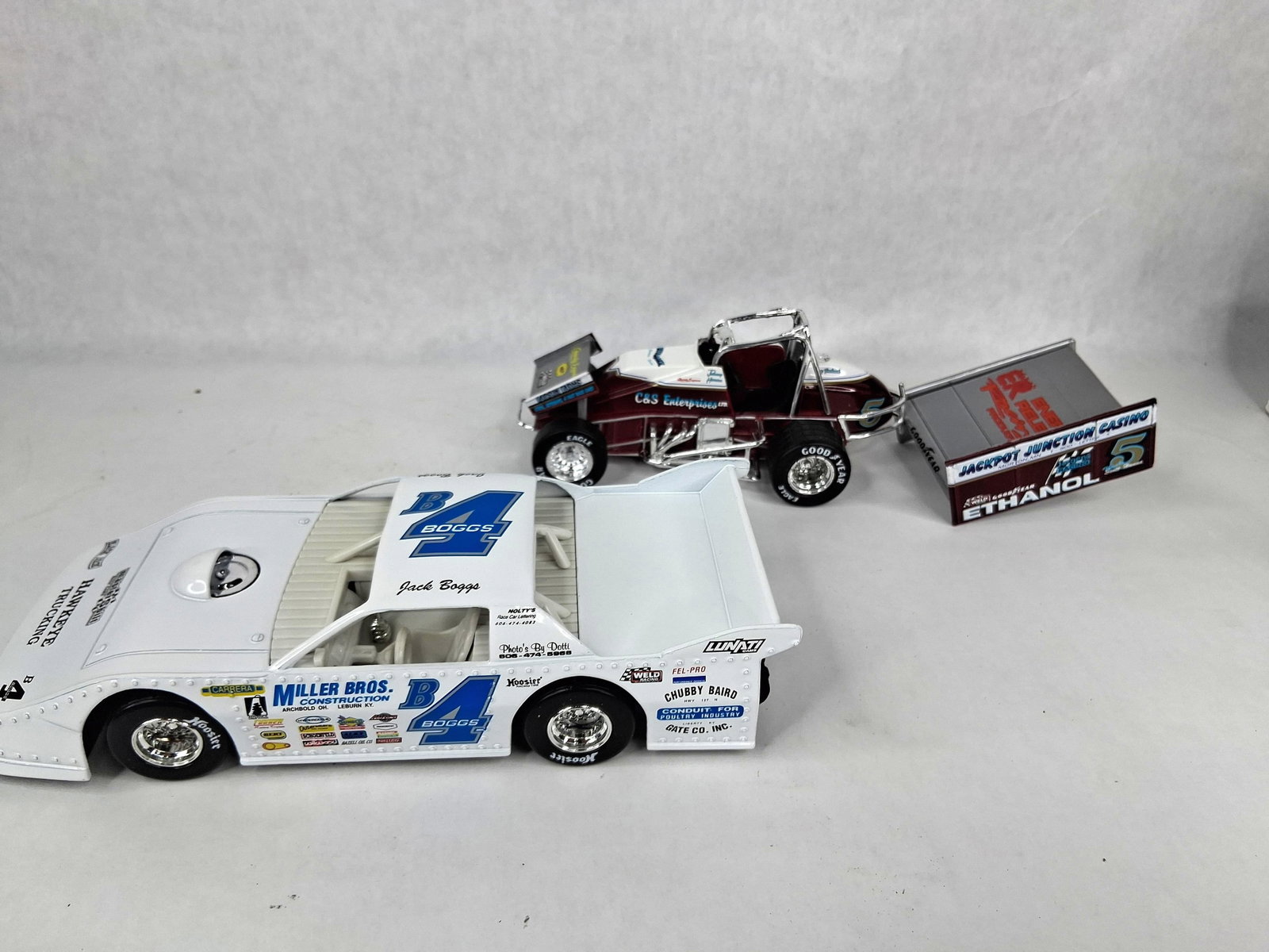 Pair 1:24 Action Die-Cast Dirt Cars: This lot comprises two 1:24 scale die-cast dirt racing cars from the Action Racing Collectibles Platinum Series, both released in 1995. The first car is a representation of the Jack Boggs #B4 dirt