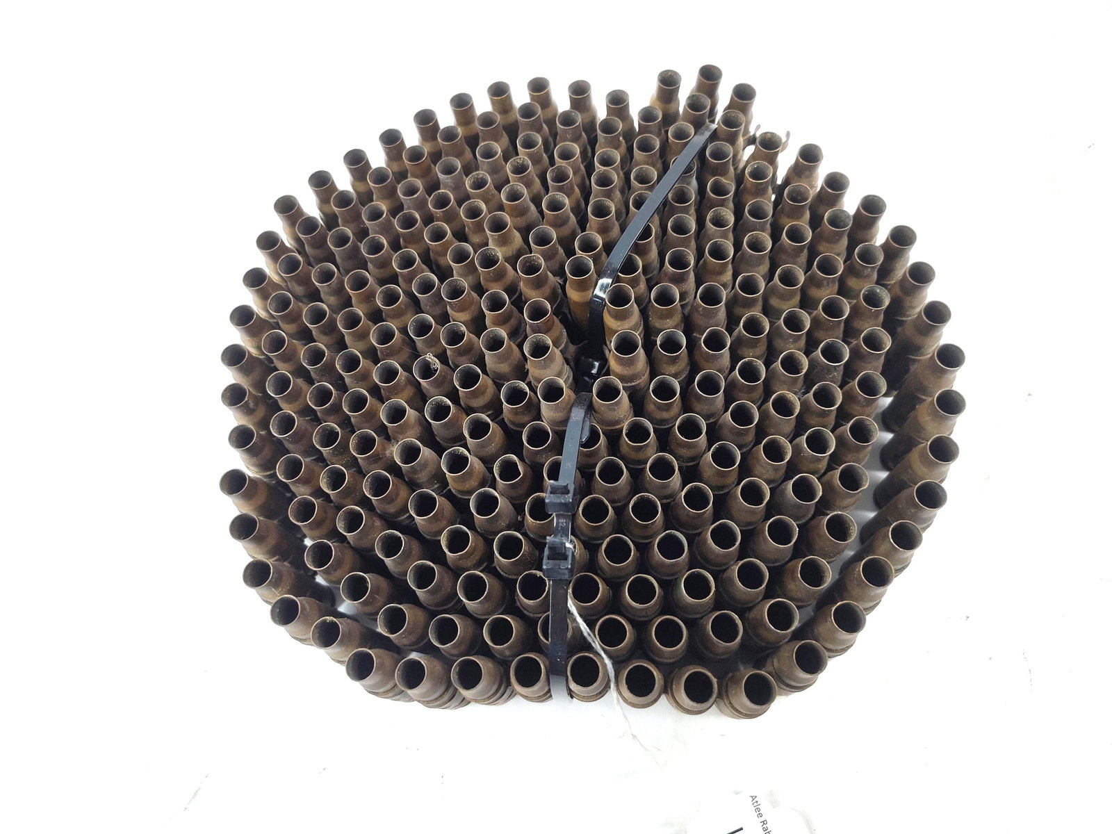 200 Winchester 7.62 NATO Casings (1966): This lot consists of 200 spent 7.62x51mm NATO ammunition casings secured within M13 disintegrating metal links. The bottlenecked, rimless brass casings are fired components, as indicated by the presen