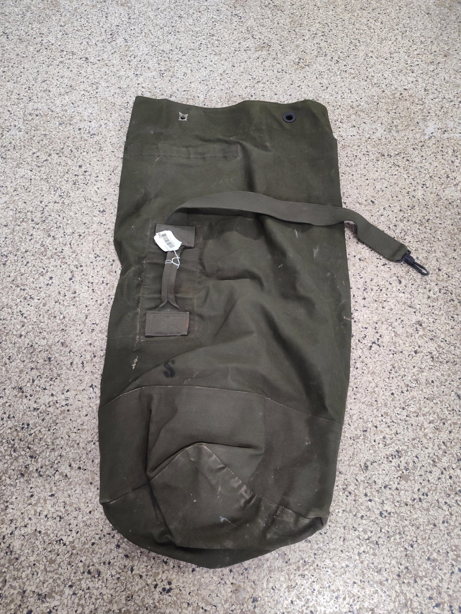 Vietnam War US Military Canvas Duffel: A Vietnam War era United States military issue top-load duffel bag, also known as a sea bag. This piece of field equipment is constructed from heavy-weight olive drab cotton canvas. The bag features a