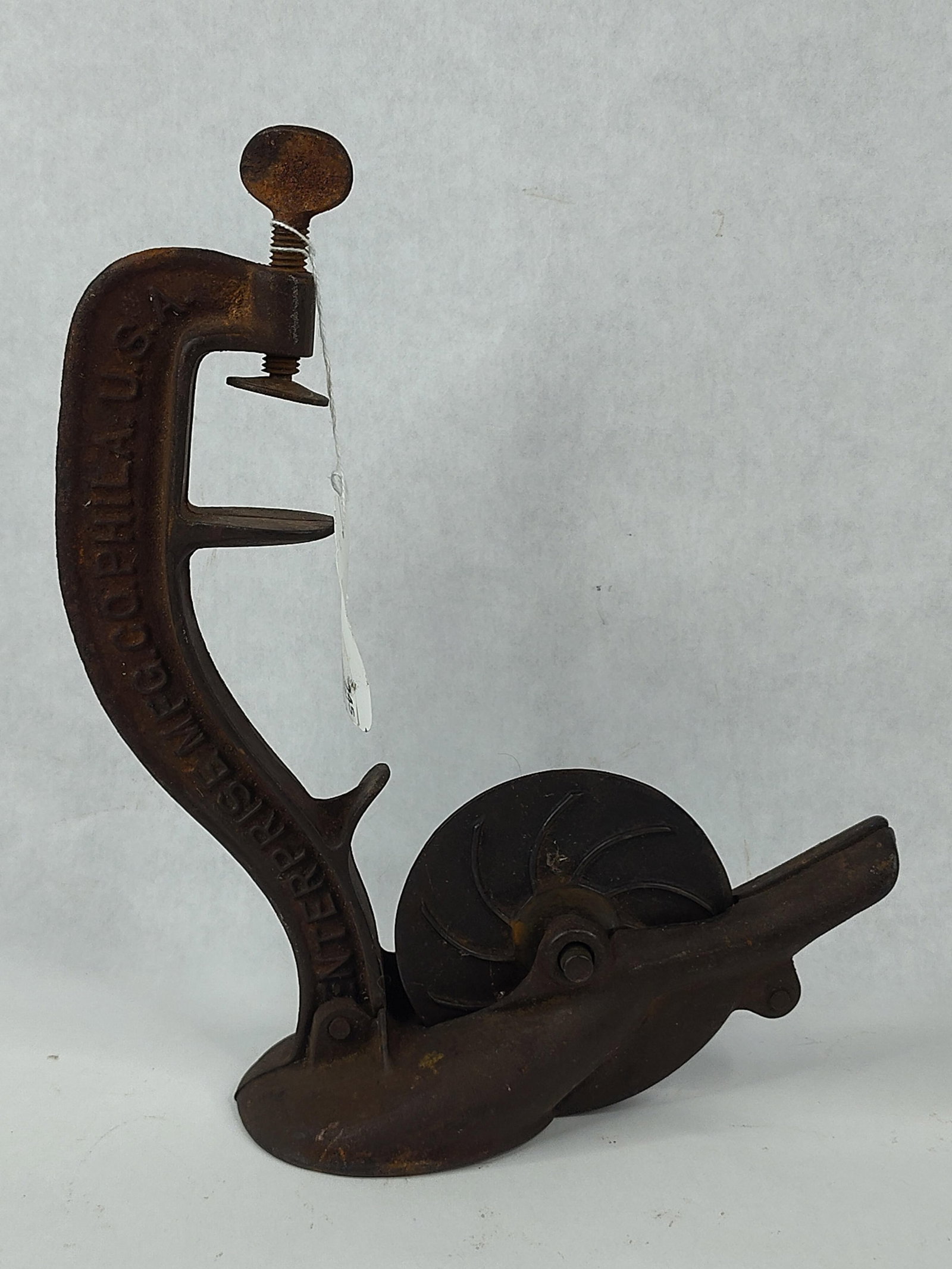 Enterprise Mfg No. 1 Iron Cherry Stoner: This antique cherry pitter is manufactured by the Enterprise Manufacturing Company of Philadelphia. The device is constructed entirely of cast iron and features a curved upright frame with an