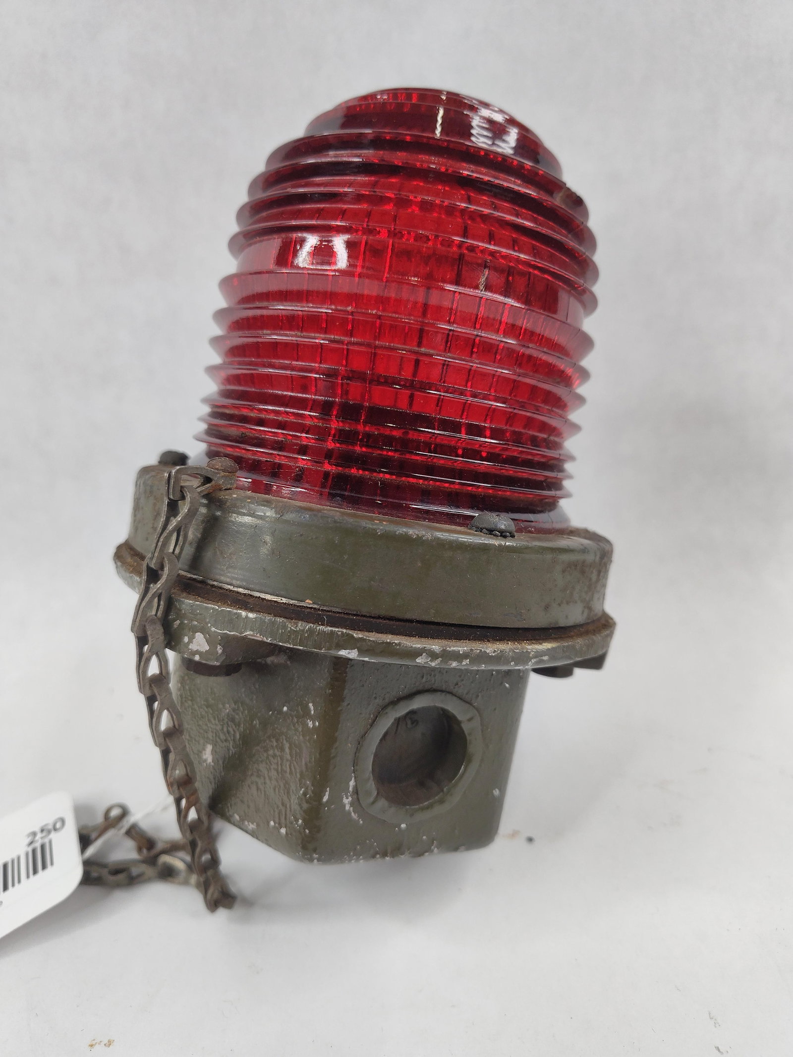 Lintern Corp Red Fresnel Signal Beacon: A industrial signal light produced by The Lintern Corporation of Painesville, Ohio. This fixture features a heavy cast metal base finished in original olive drab paint, suggesting application in