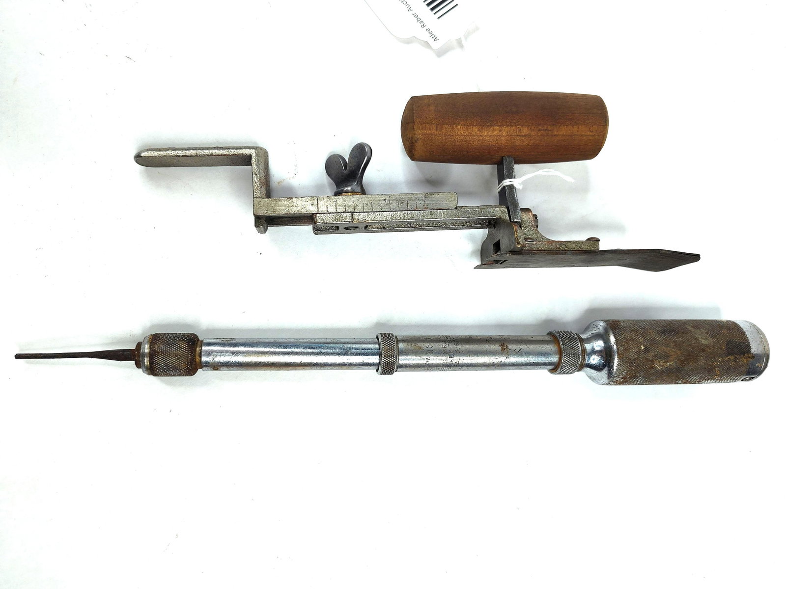 Stanley Jointer Gauge & Yankee 41 Drill: This lot features two American-made hand tools. The first is a Stanley No. 386 jointer gauge, a woodworking accessory made of cast iron and steel with a turned wooden handle. It is designed to clamp