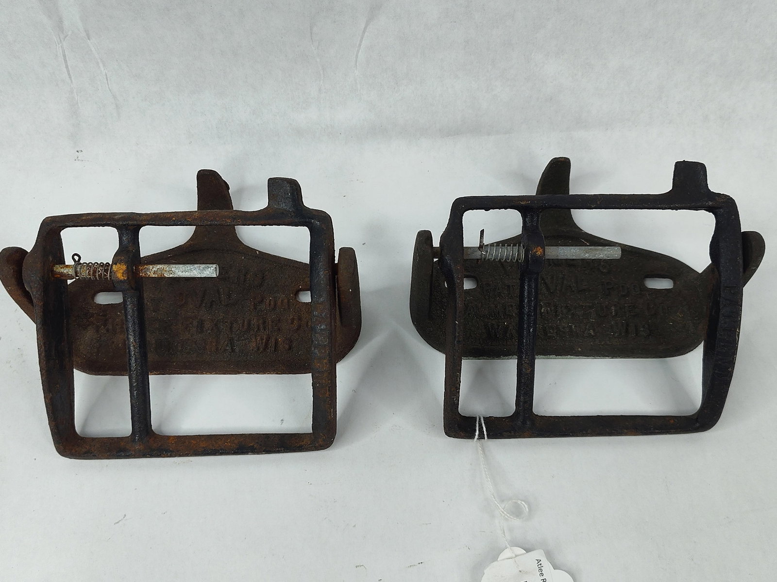Pair Palmer Iron Toilet Paper Holders: A pair of early 20th-century industrial wall-mount toilet paper dispensers manufactured by the Palmer Fixture Company in Waukesha, Wisconsin. Each unit is constructed from heavy cast iron and