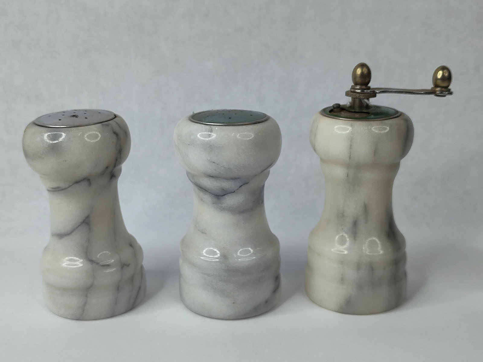 Vtg Carved Marble Salt, Pepper & Mill: This set of three tabletop kitchen accessories consists of a salt shaker, a pepper shaker, and a manual pepper mill. Each piece is crafted from solid white marble featuring natural gray veined pattern