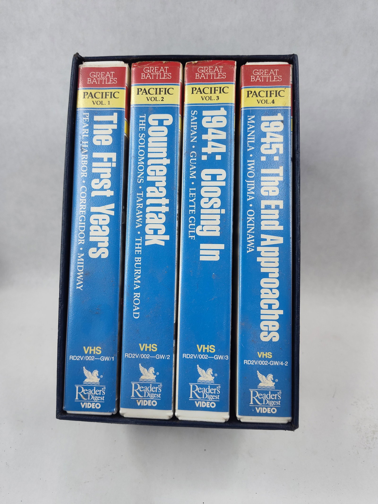 Reader's Digest Victory Pacific VHS Set: This four-volume VHS box set is titled Great Battles of World War II: Victory in the Pacific, published by Reader's Digest Video. The collection is housed in a dark blue pebbled-texture slipcase with 