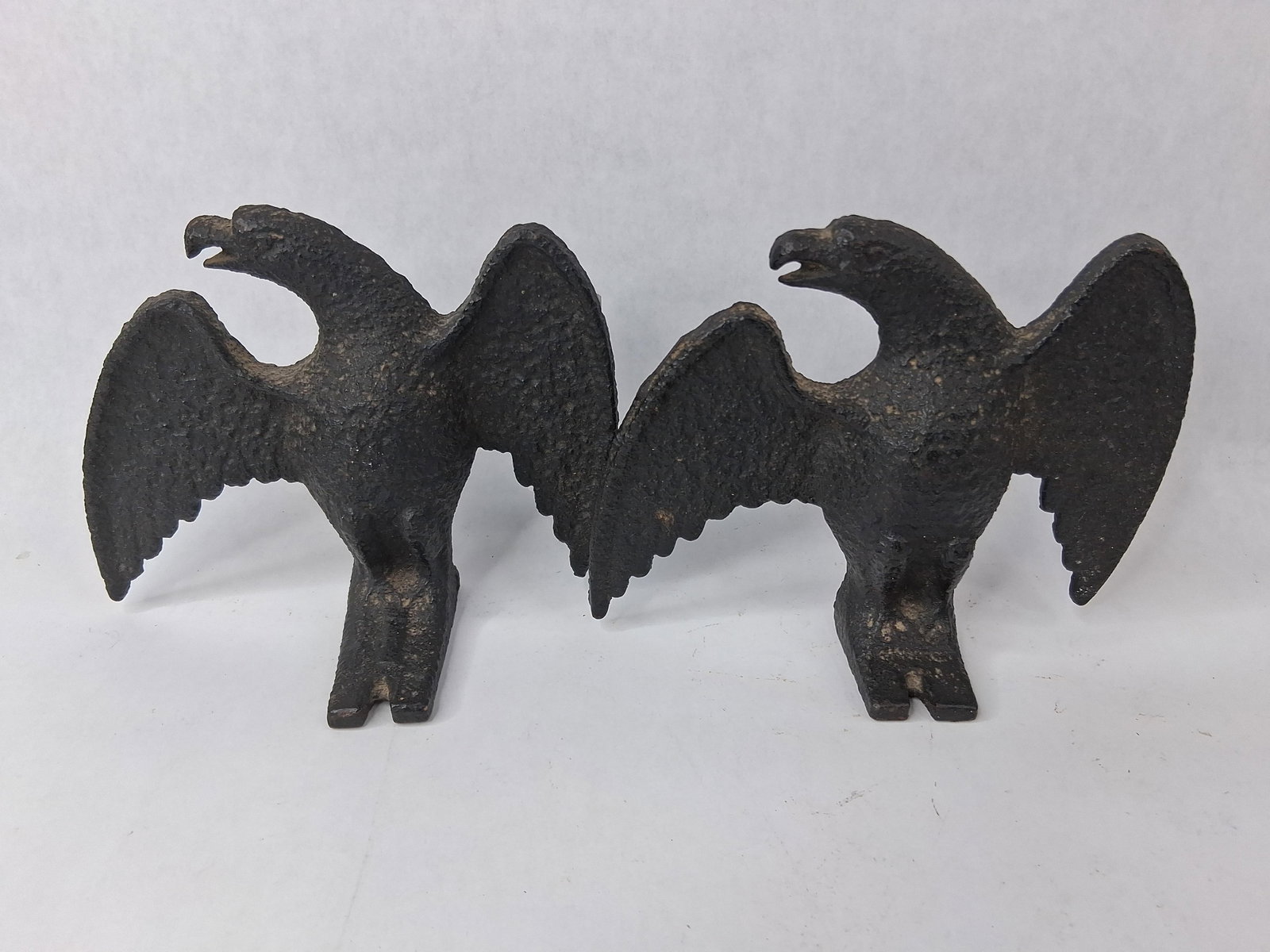 Pair Cast Iron Eagle Roof Snow Guards: This pair of cast iron architectural elements, historically referred to as snow eagles or snow birds, was designed for use on slate or shingle roofs to prevent large accumulations of snow from sliding