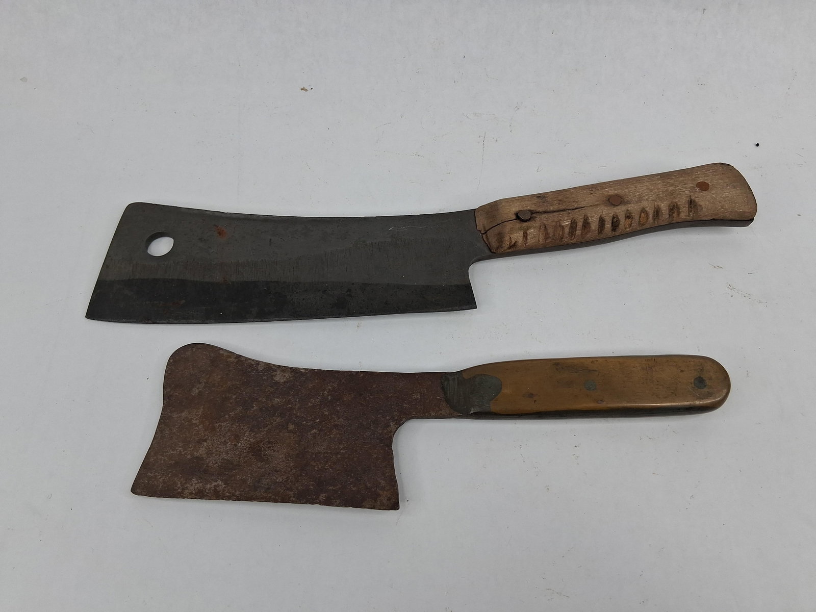 Pair Vtg Solingen Carbon Steel Cleavers: Two fixed-blade meat cleavers featuring carbon steel construction and full tangs. The larger cleaver is stamped on the left side of the blade with the mark HB 2 SOLINGEN, identifying it as a German-ma