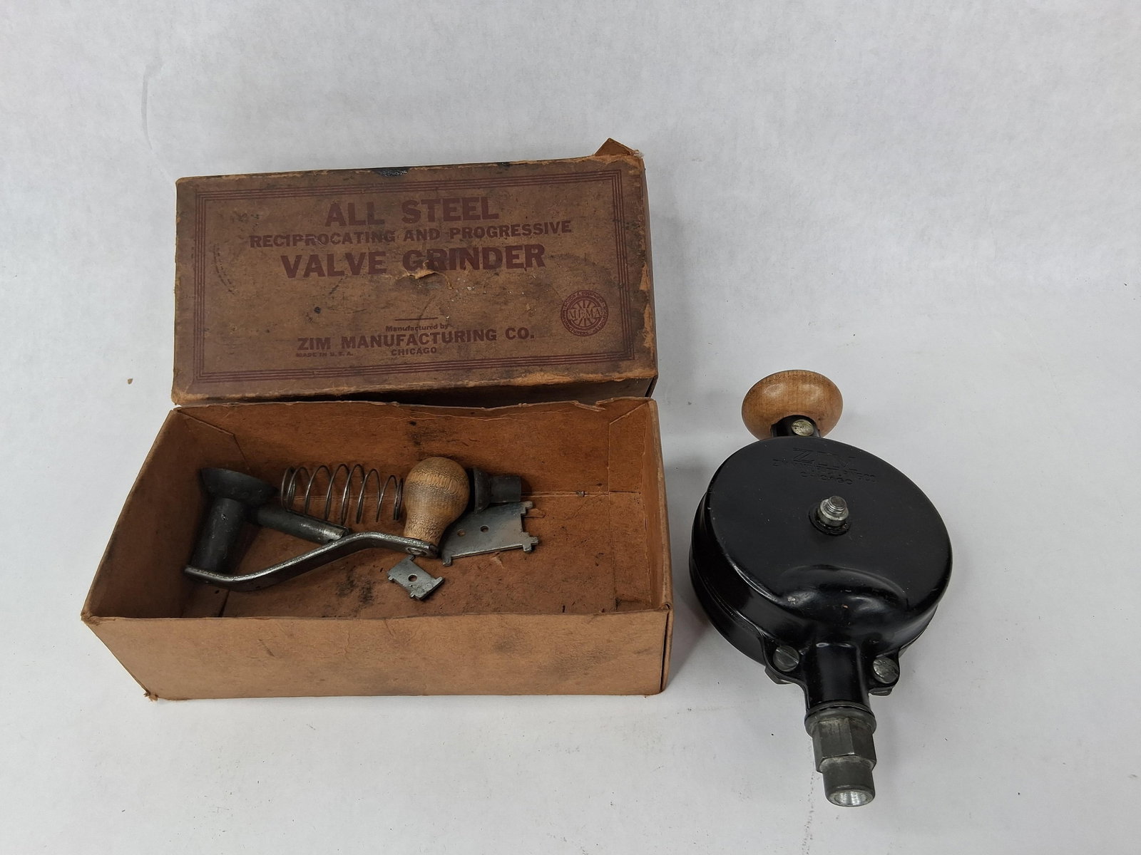 Zim No. 301 Valve Grinder w/Orig. Box: Zim Manufacturing Co. No. 301 reciprocating and progressive valve grinder. This set includes the primary tool housing, an auxiliary hand-crank, a valve spring, a rubber suction cup attachment, and two