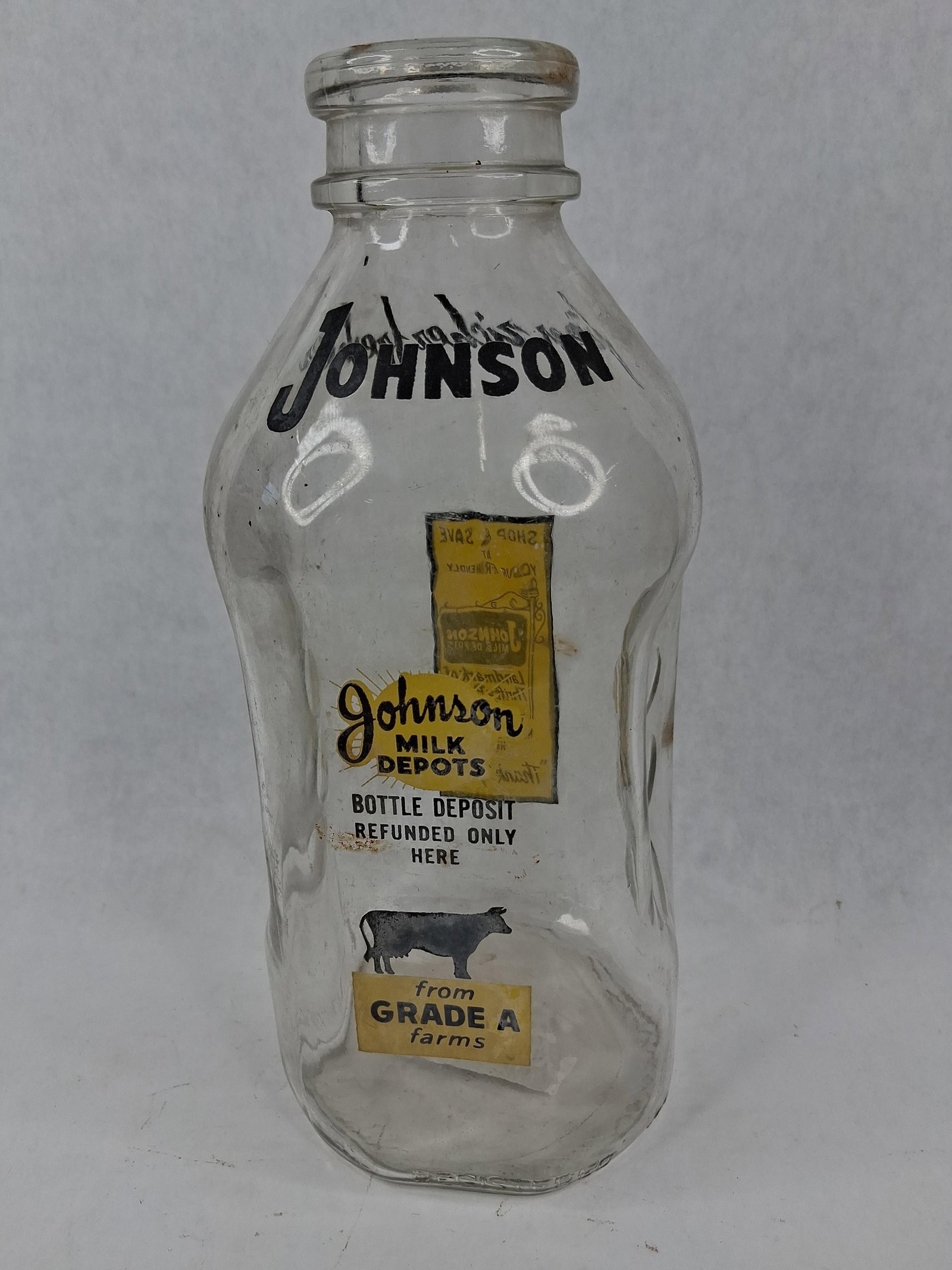 Johnson Milk Depots Detroit Milk Bottle: This one-quart square-style clear glass milk bottle is from Johnson Milk Depots, a dairy company historically located in Detroit, Michigan. The bottle is decorated with black and yellow pyroglaze, als