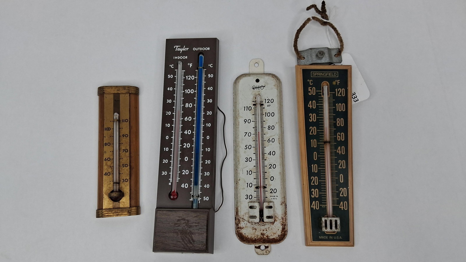 Taylor, Ohio & Springfield Thermometers: A collection of five thermometers from prominent American manufacturers including Taylor, Ohio, and Springfield Instrument Co., Inc. The assortment includes various designs and materials reflecting 20