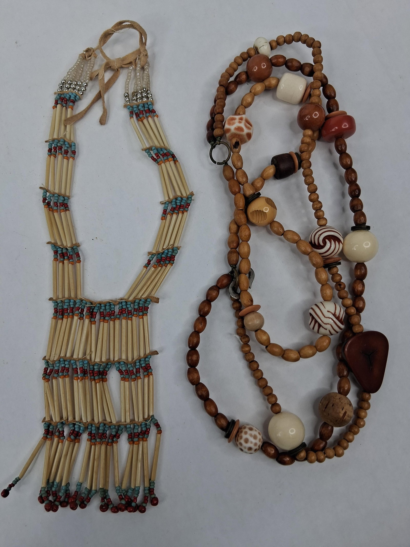 Hair Pipe Breastplate & Beaded Strand: This lot features two necklaces of distinct styles. The first is a multi-strand breastplate style necklace of Southwestern design. It is constructed with vertical hair pipe beads of an off-white tone,