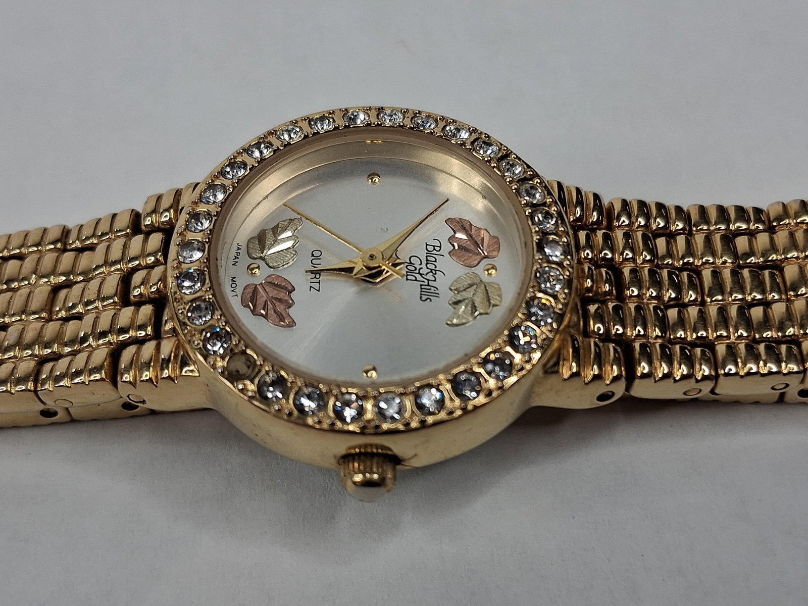 Black Hills Gold 12K Gold Leaf Watch: This ladies dress watch is produced by Black Hills Gold and features a gold-tone base metal case with a crystal-set bezel. The silver-tone sunray dial is detailed with four applied leaf motifs crafted