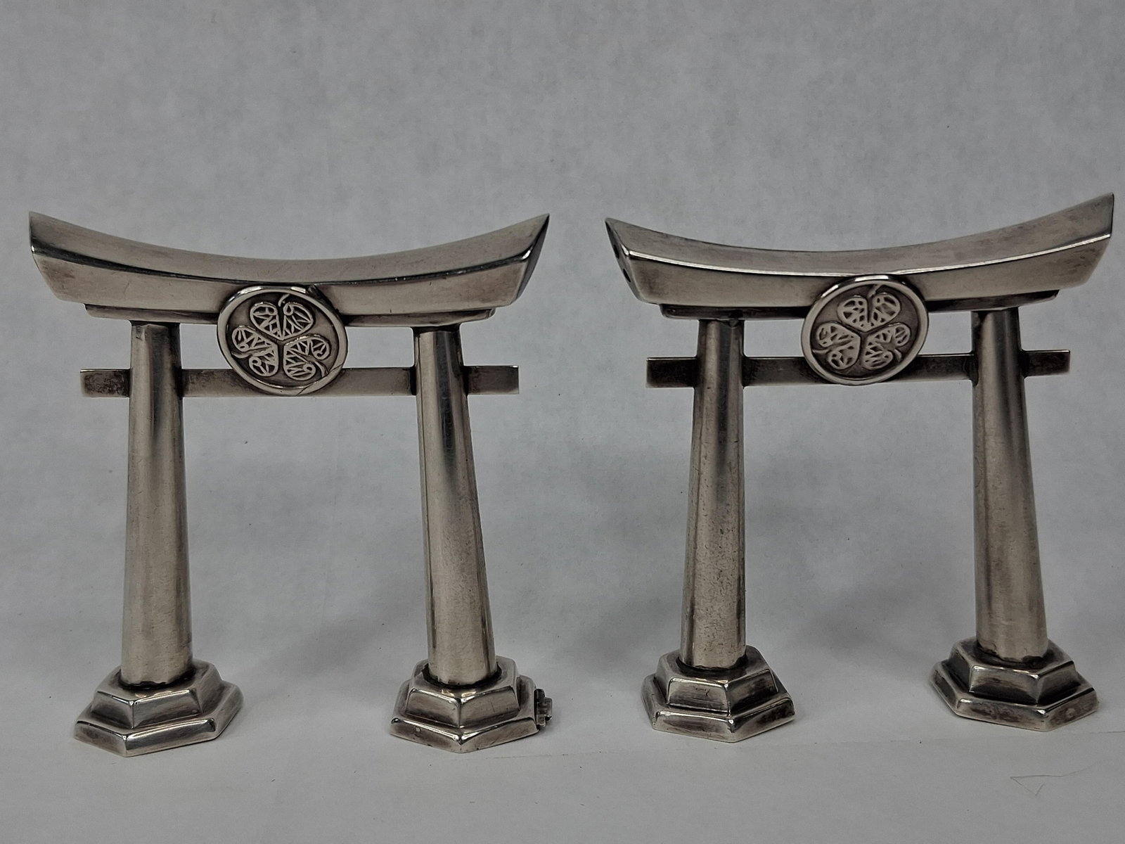 Pair Japanese 950 Silver Torii Gate S&P: A pair of silver miniatures modeled as traditional Japanese Shinto shrine gates (Torii). Each gate is constructed with a curved top rail (kasagi), a straight lower horizontal rail (nuki), and two