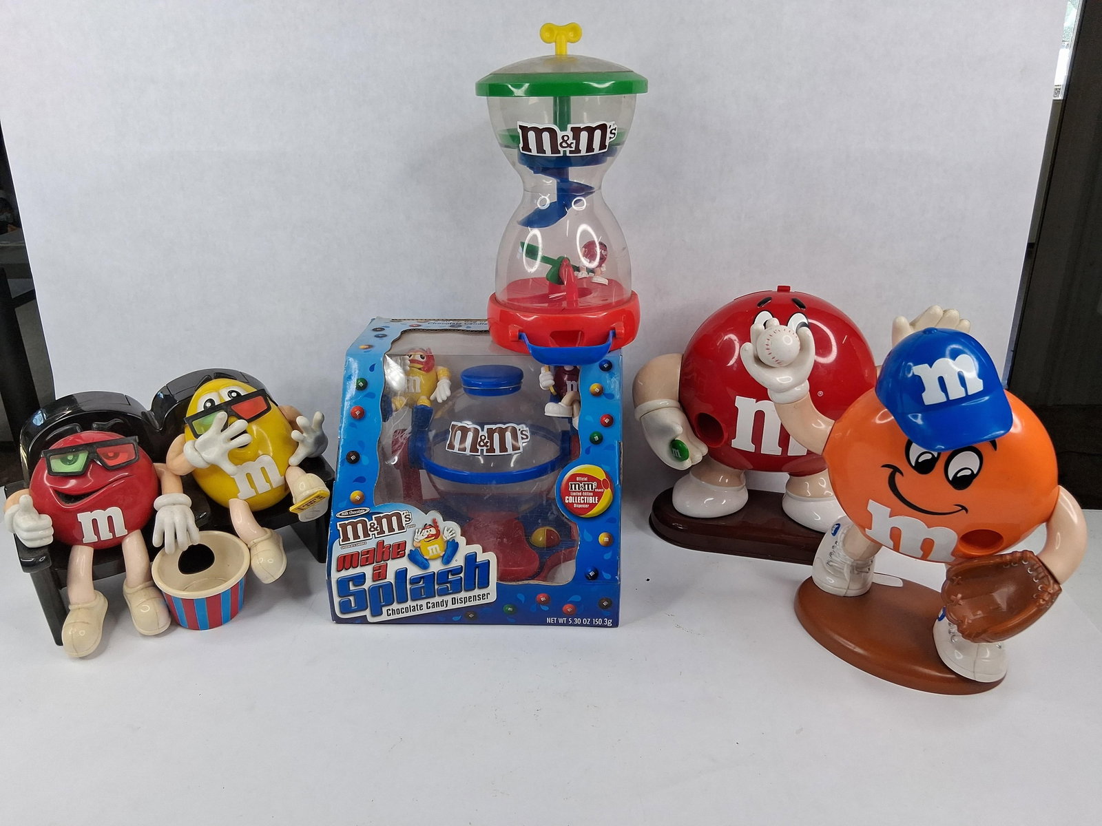 M&M's Character Candy Dispensers: This group of M&M's brand collectible merchandise consists of molded plastic candy dispensers manufactured for Mars Inc. The group includes several themed character models. Included is a
