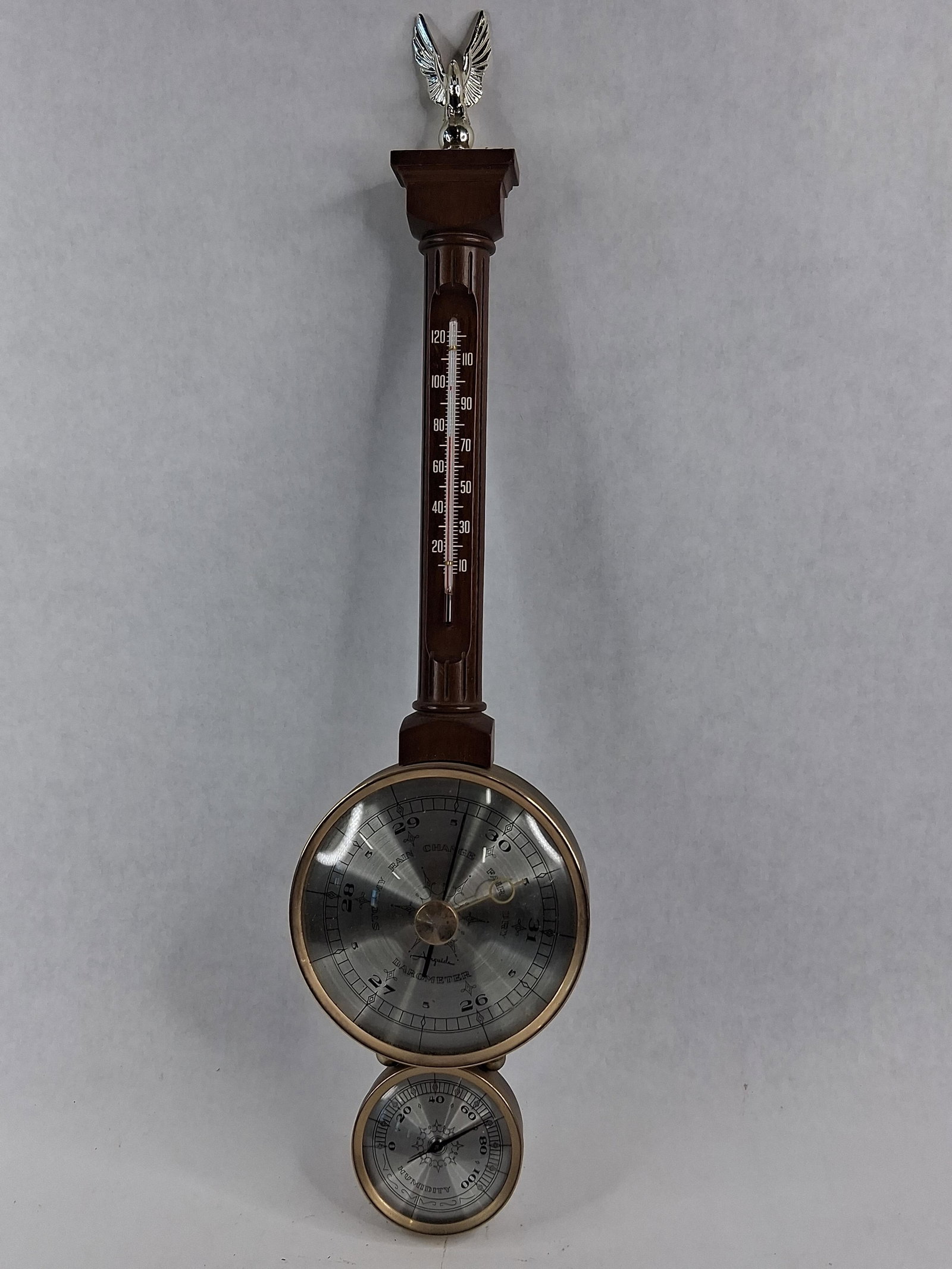 Airguide Banjo Weather Station w/ Eagle: A mid-century American banjo-style wall weather station manufactured by Airguide (Fee & Stemwedel, Inc.). The instrument features a dark wood-grained molded composite case topped with a silver-toned