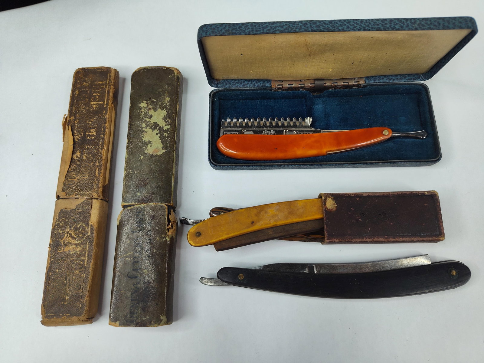 5 Vtg Durham Duplex & Geneva Razors: An assortment of shaving implements and accessories comprising five razors and several original storage boxes. The collection features a Durham Duplex safety straight razor with translucent orange