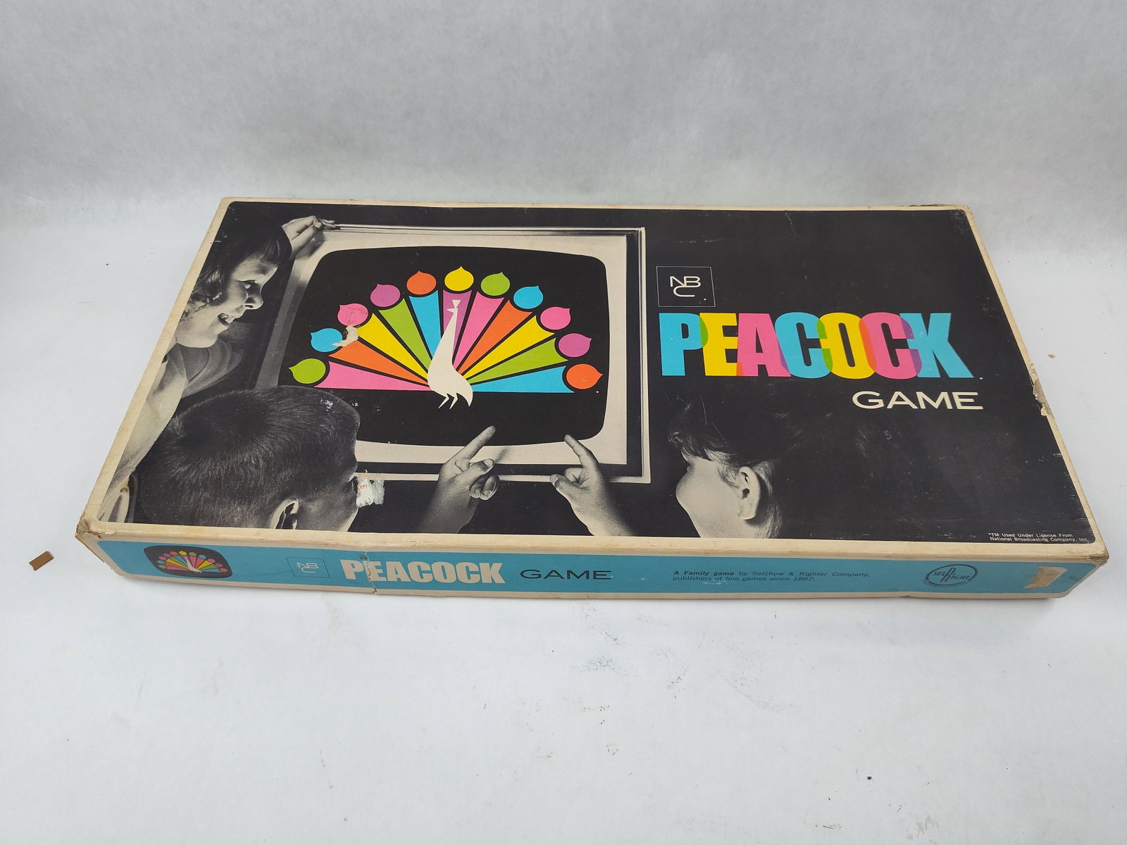 Selchow & Righter NBC Peacock Game 1966: NBC Peacock Game manufactured by the Selchow & Righter Company under license from the National Broadcasting Company, Inc., copyright 1966. This board game consists of a printed cardboard bi-fold game 