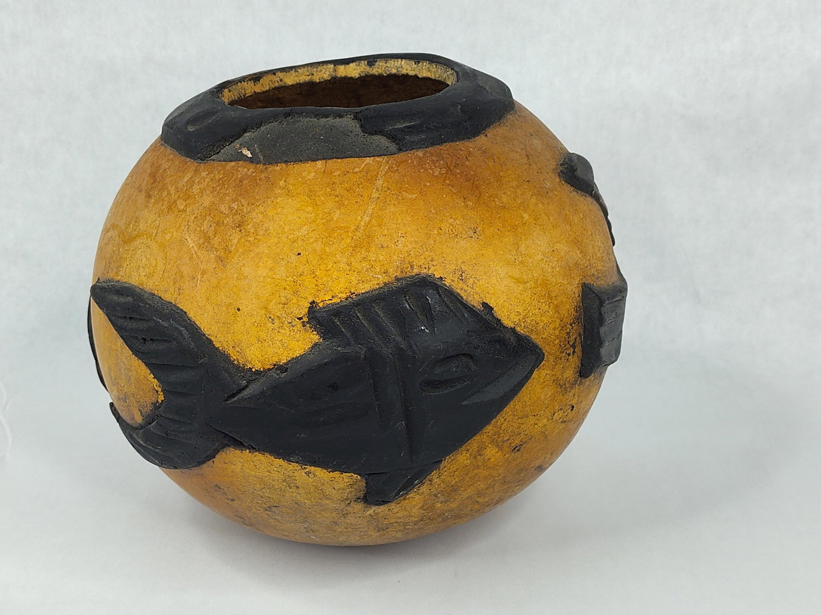 Peruvian Zoomorphic Mate Burilado Gourd: This spherical decorative vessel is a Peruvian mate burilado, a traditional form of folk art from the Huancayo region, specifically the villages of Cochas Chico and Cochas Grande. The piece is