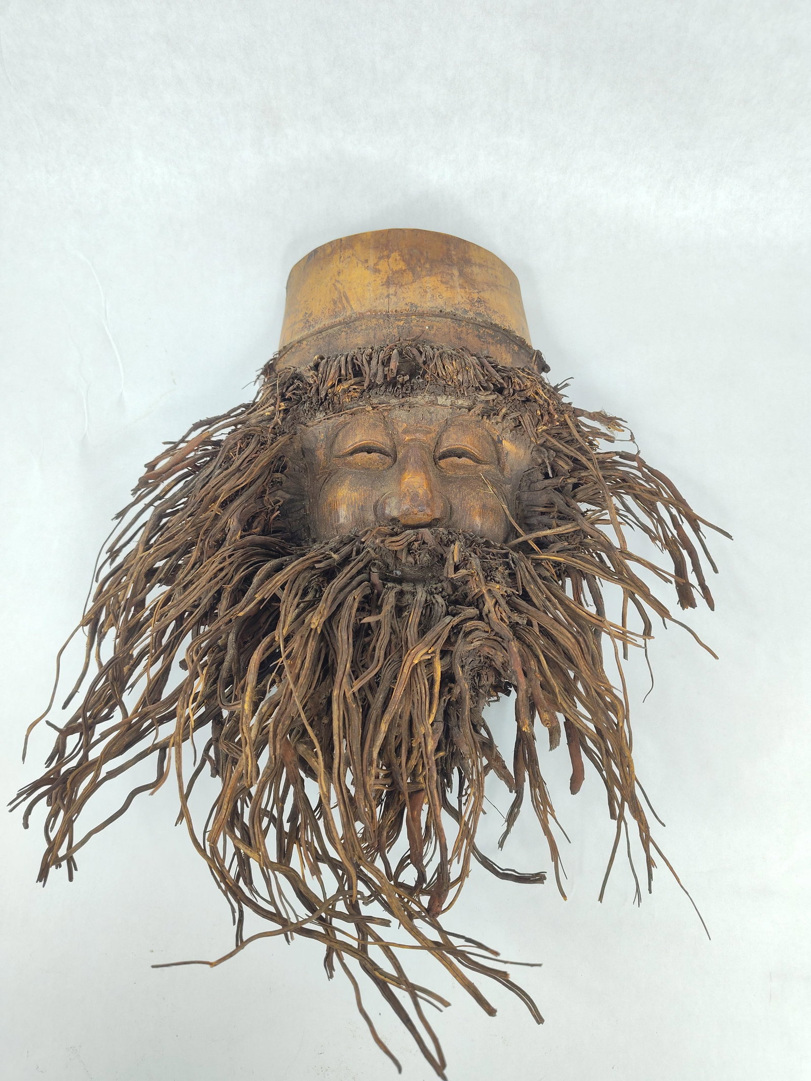 Chinese Bamboo Root Shou Lao Sculpture: This Chinese wall sculpture is hand-carved from a single bamboo root or rhizome. The figure depicts the immortal Shou Lao, the God of Longevity, characterized by a prominent forehead and a jovial,