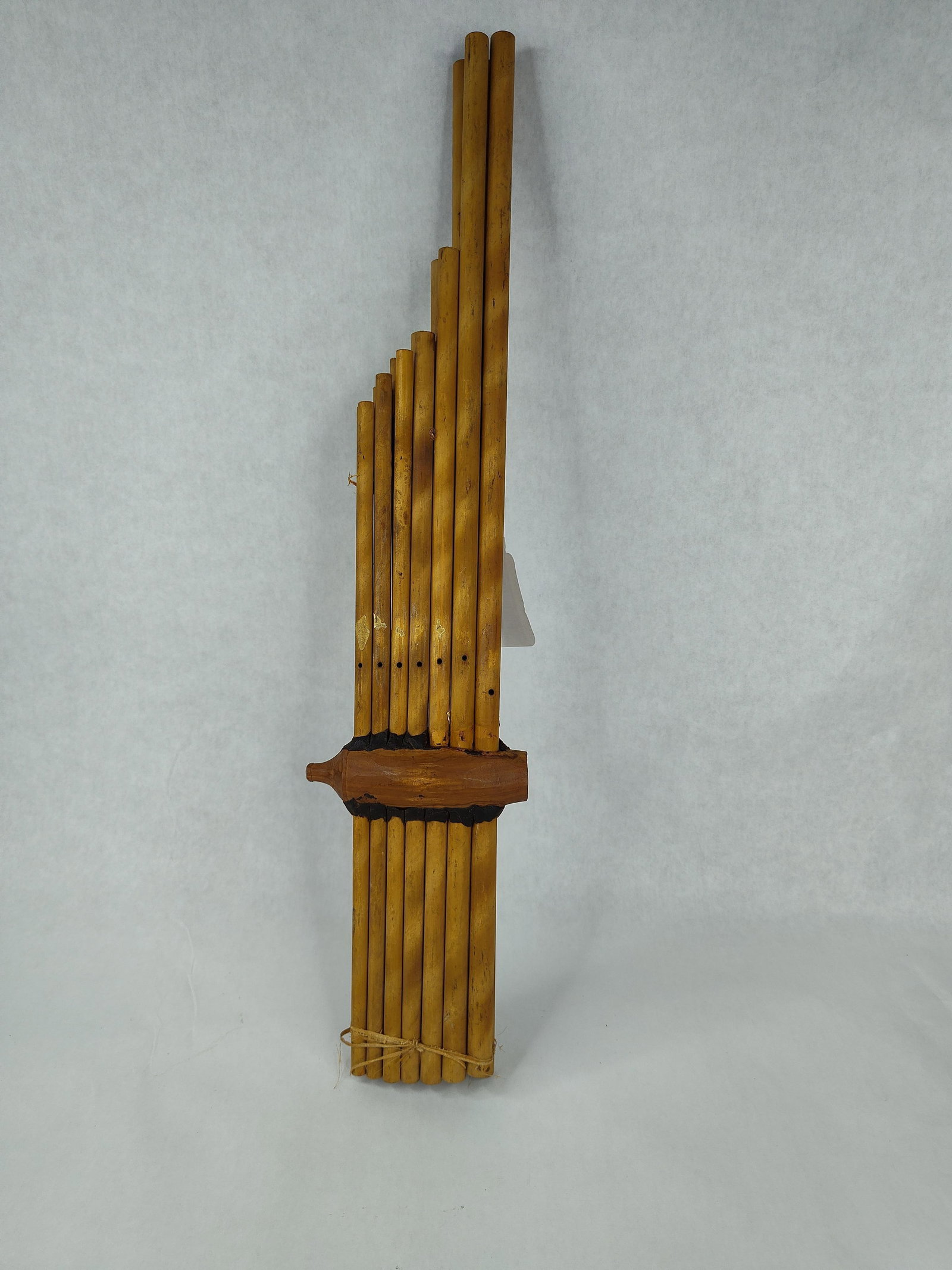 Thai Bamboo Khaen Mouth Organ: A Southeast Asian mouth organ, known as a khaen or khene, traditional to the Isan region of Thailand and Laos. The instrument is constructed from fourteen bamboo pipes of varying lengths arranged in t