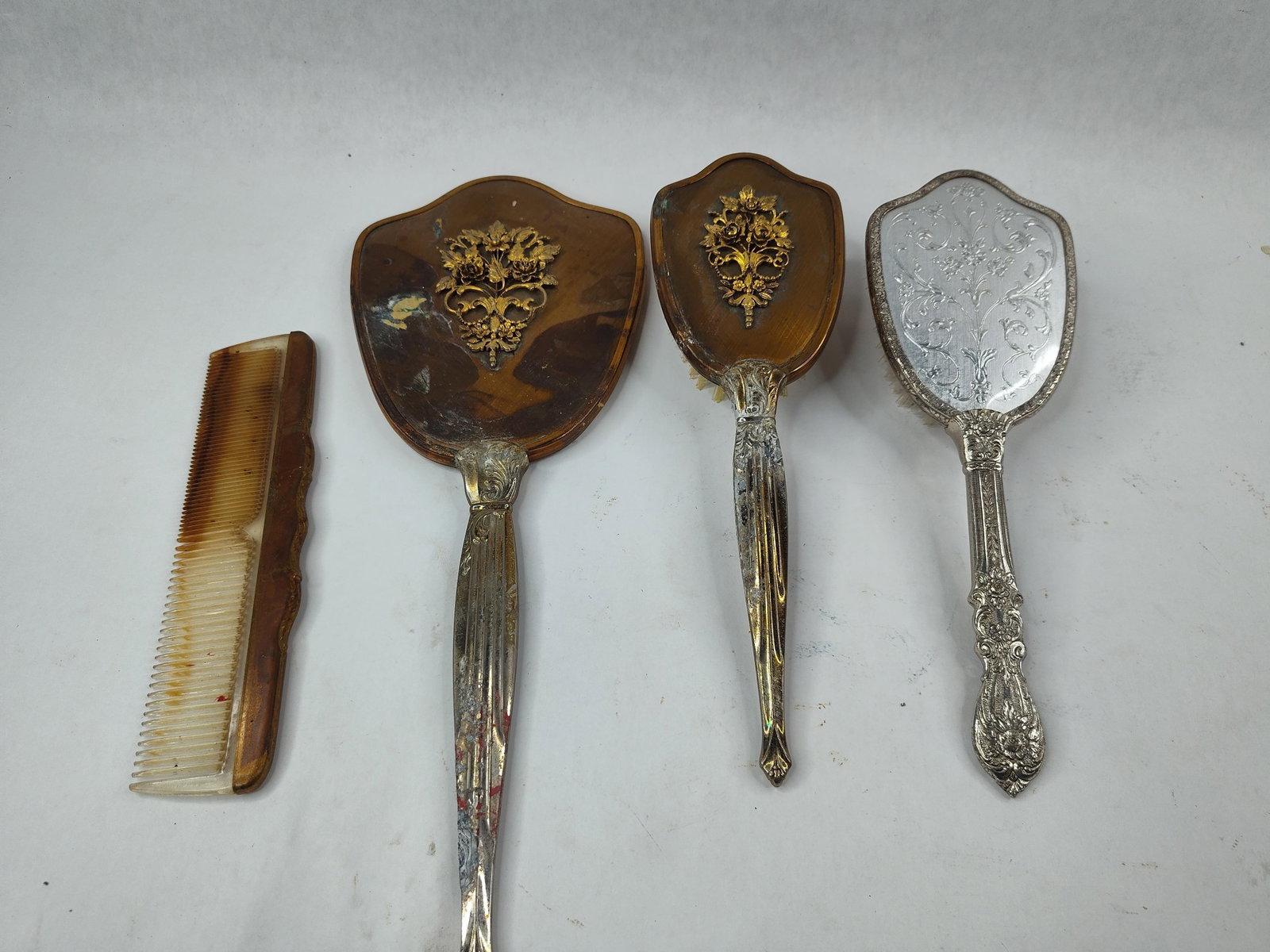 Vtg Hollywood Regency Vanity Access: This vanity collection features silver-plated and faux tortoiseshell accessories in two distinct decorative motifs. Three matching pieces?a hand mirror, a hairbrush, and a hair comb?are constructed