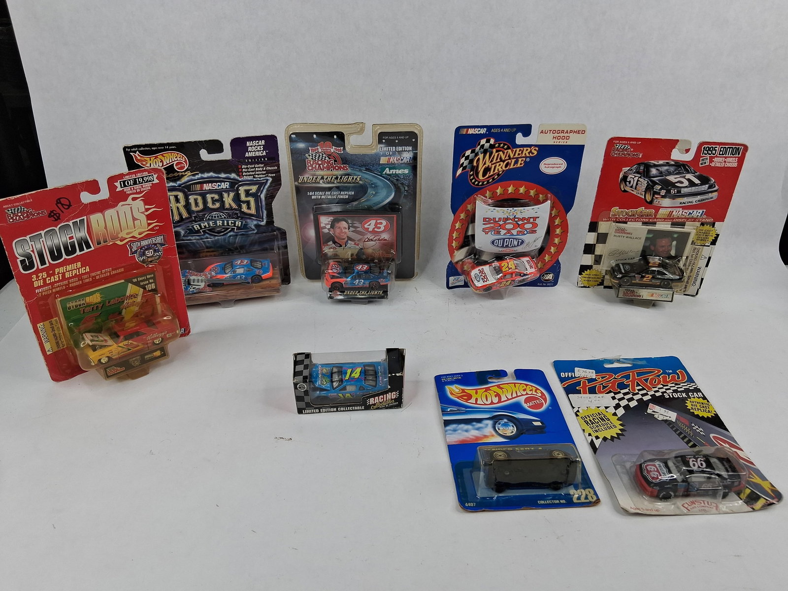 8 NASCAR & Die-Cast Replica Vehicles: This collection features eight 1:64 scale die-cast replica vehicles from manufacturers including Racing Champions, Mattel (Hot Wheels), Winner?s Circle, Racing Collectables Club of America, and Pit Ro