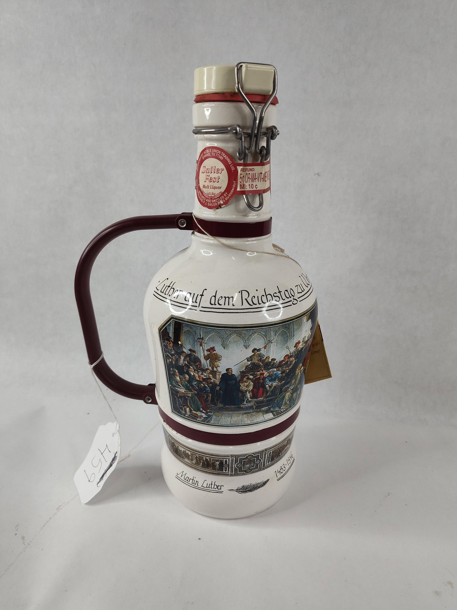 Martin Luther Sailer Fest Growler: Produced by Brauerei F.J. Sailer of Marktoberdorf, Germany, this commemorative growler was manufactured for Sailer Fest Malt Liquor. The vessel features a white glazed ceramic body decorated with a