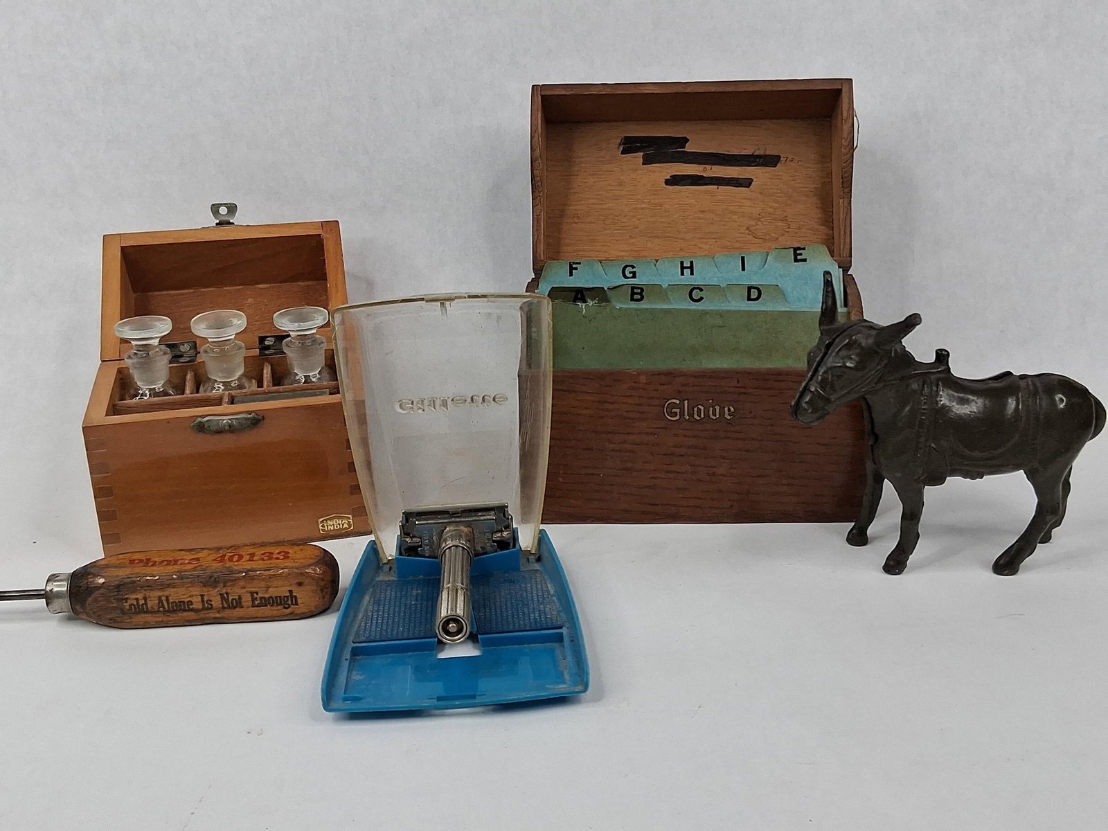 Gillette Razor, H.S. Kit & Donkey Bank: An assortment of collectibles featuring a grooming tool, jeweler equipment, a still bank, and advertising items. The lot includes a Gillette Slim Adjustable safety razor constructed from
