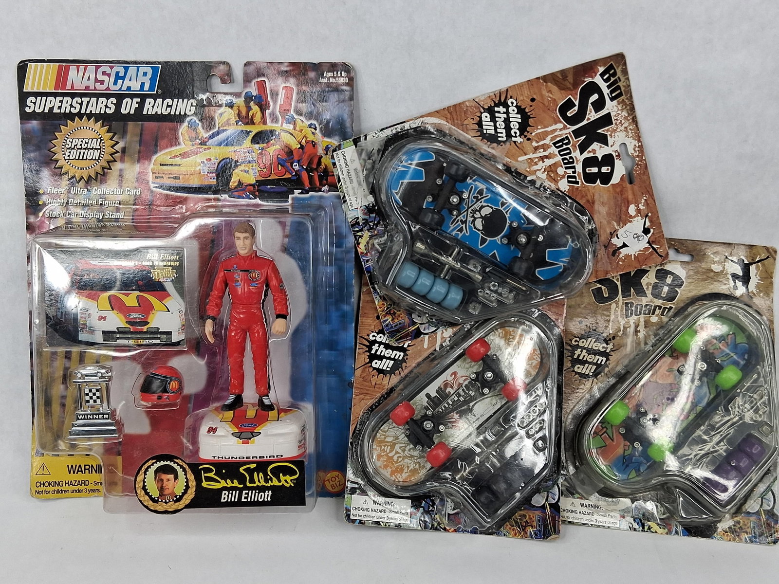 Toy Biz & Novelty NASCAR Finger Skates: This lot consists of four unopened collectible toy sets including one NASCAR action figure and three finger skateboards. The first item is a Toy Biz NASCAR Superstars of Racing Special Edition set