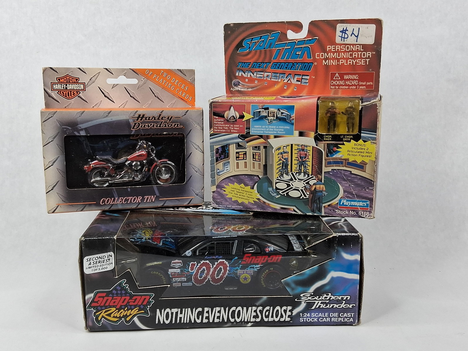 Star Trek, Snap-on Car & Harley Cards: Three collectibles in original packaging featuring pop culture and automotive brands. The first item is a Playmates Star Trek: The Next Generation InnerSpace Series Personal Communicator