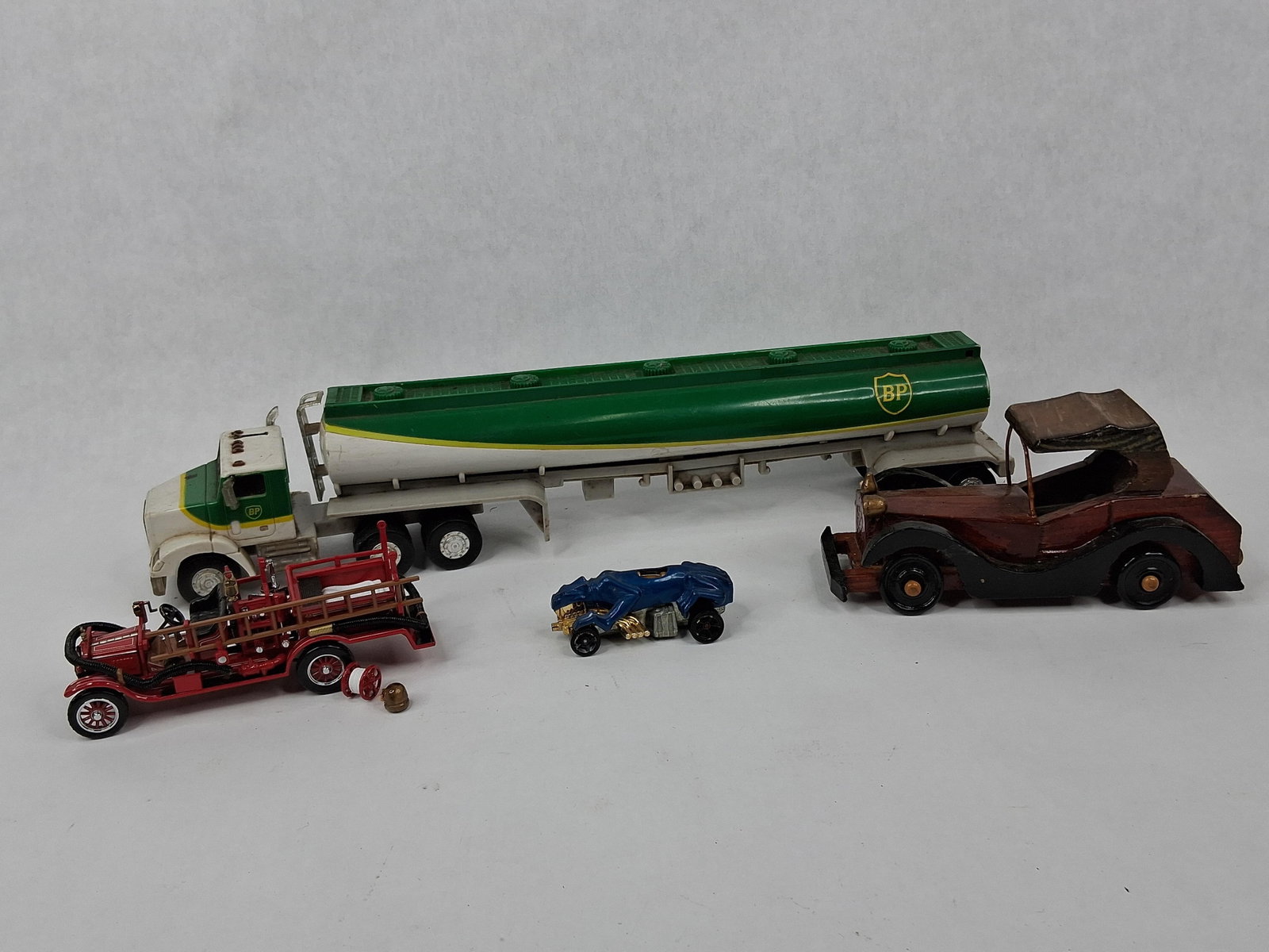 BP Tanker & Hot Wheels Double Demon: An assortment of toy vehicles comprising promotional, die-cast, and handmade examples. The collection includes a BP promotional tanker truck, identified as a 1991 Limited Edition series model. This