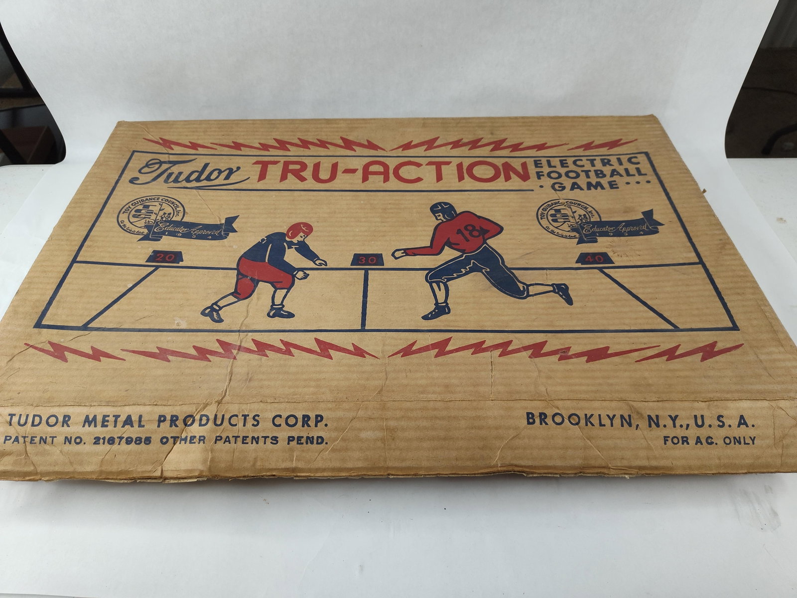 Tudor Tru-Action Electric Football Game: A Tudor Tru-Action Electric Football Game, manufactured by the Tudor Metal Products Corp. of Brooklyn, New York. This Model No. 500 set features a rectangular metal playing field finished in dark