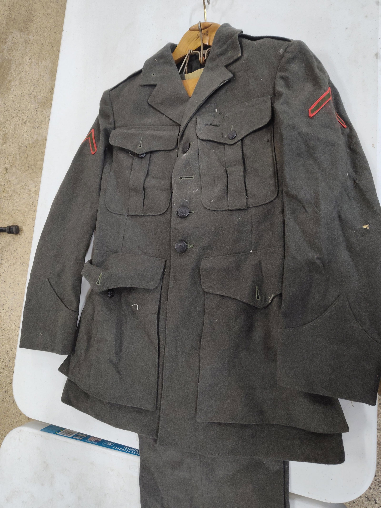 WWII USMC M1942 Uniform: G.M. Keriotis: A United States Marine Corps M1942 pattern forest green wool service uniform, consisting of a service coat and matching trousers. The coat features a four-pocket design with bellows-style