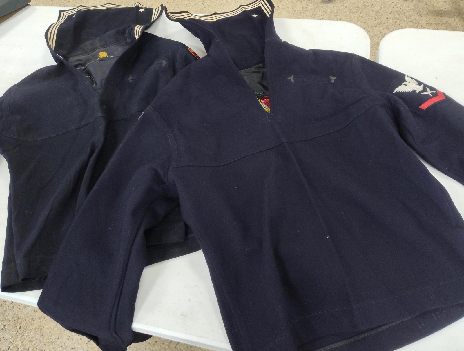 Pair US Navy WWII-Korea Liberty Jumpers: This lot consists of two US Navy Enlisted Men's Dress Blue Jumpers, a 100% navy blue wool uniform pattern colloquially known as Cracker Jacks. The first jumper features Gunner's Mate 3rd Class (GM3)