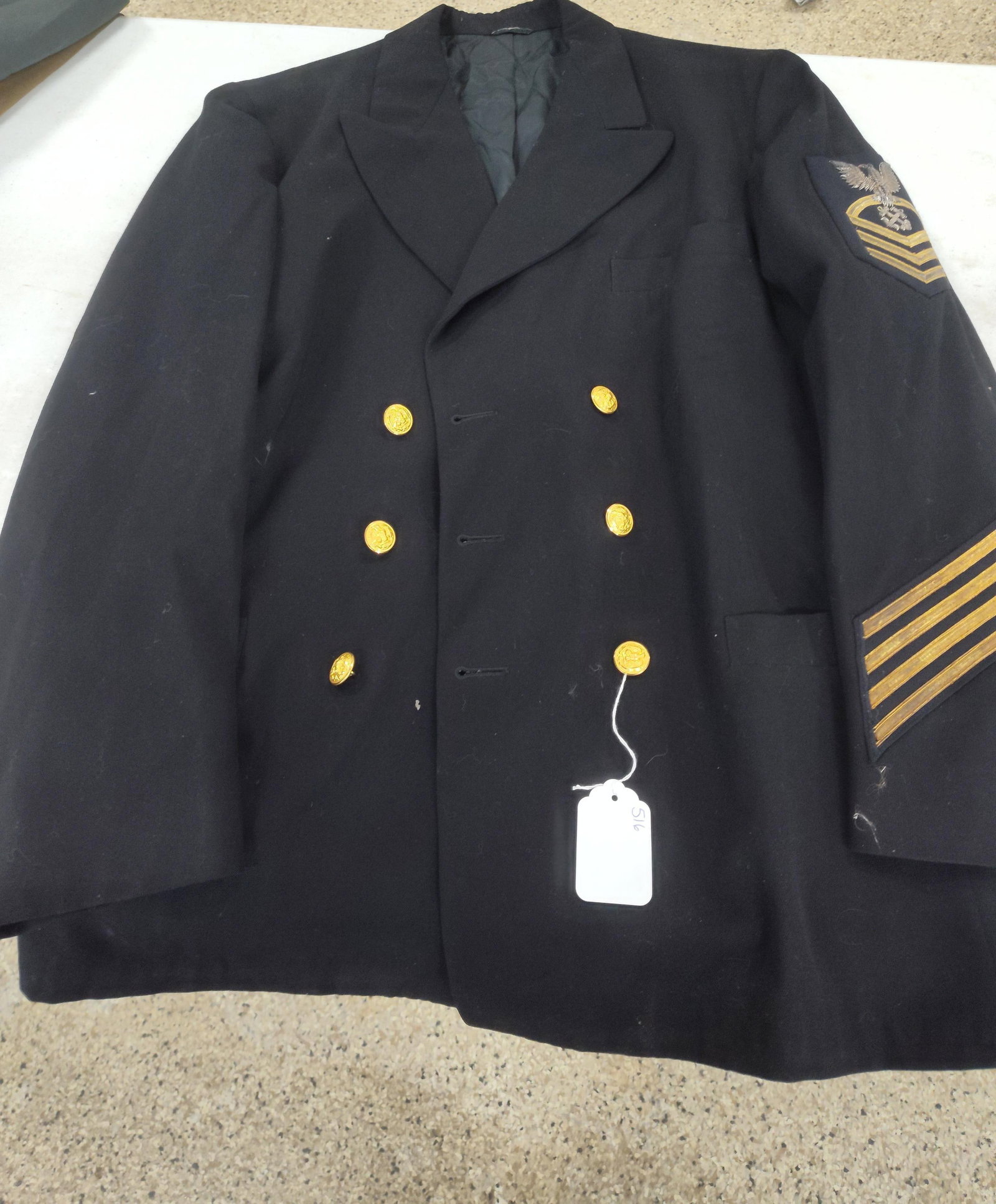Davis US Navy Chief Gunner's Mate Coat: A mid-20th century United States Navy Chief Petty Officer Service Dress Blue uniform coat manufactured by the Davis Clothing Co. of Boston, Massachusetts. The garment is a double-breasted tunic made