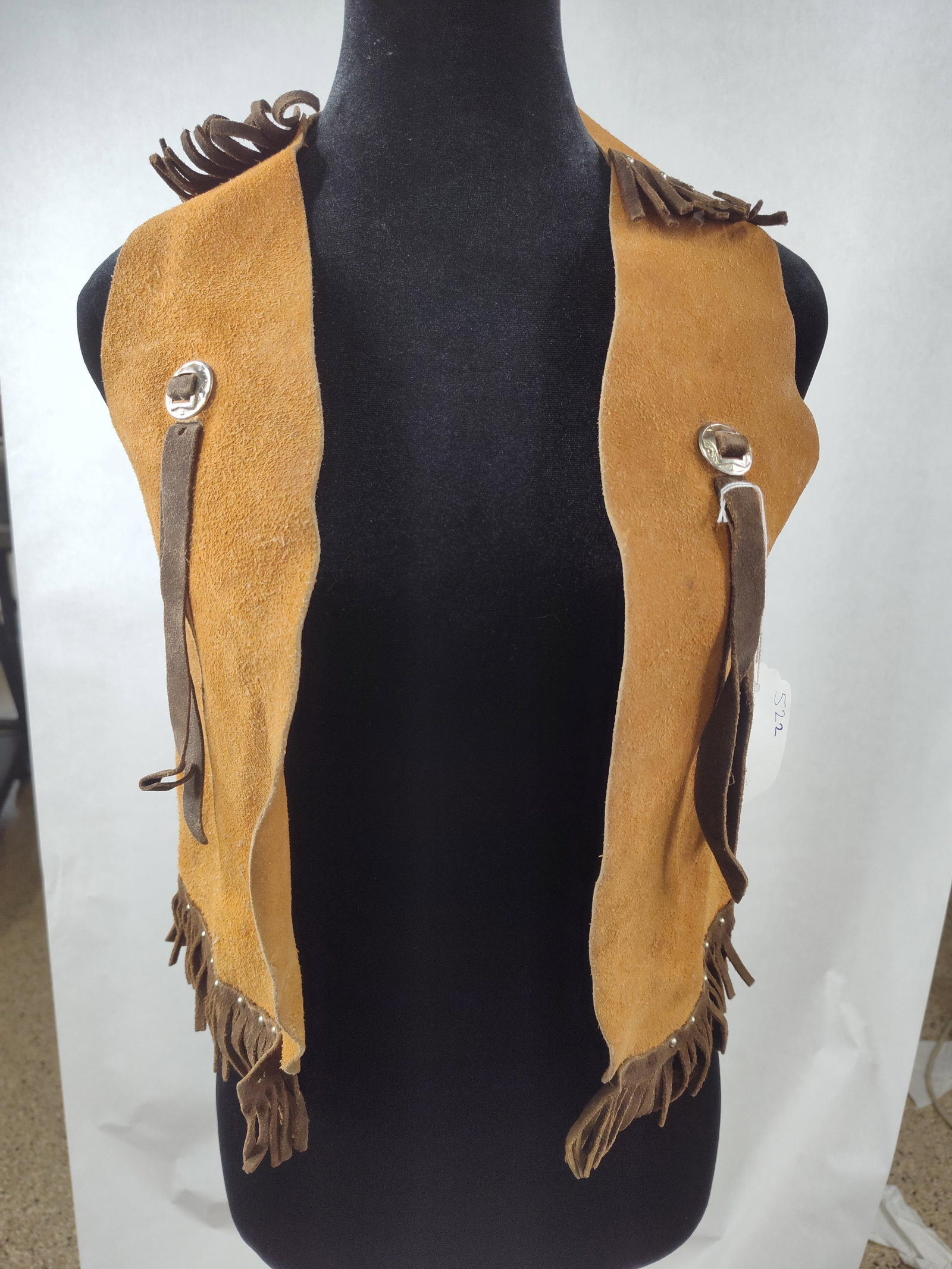 Vtg Western Suede Fringe Vest w/Conchos: This is a Western-style vest crafted from tan rough-out suede leather. The garment features an unlined, open-front design with straight-cut raw edges. Contrasting dark brown suede fringe is applied