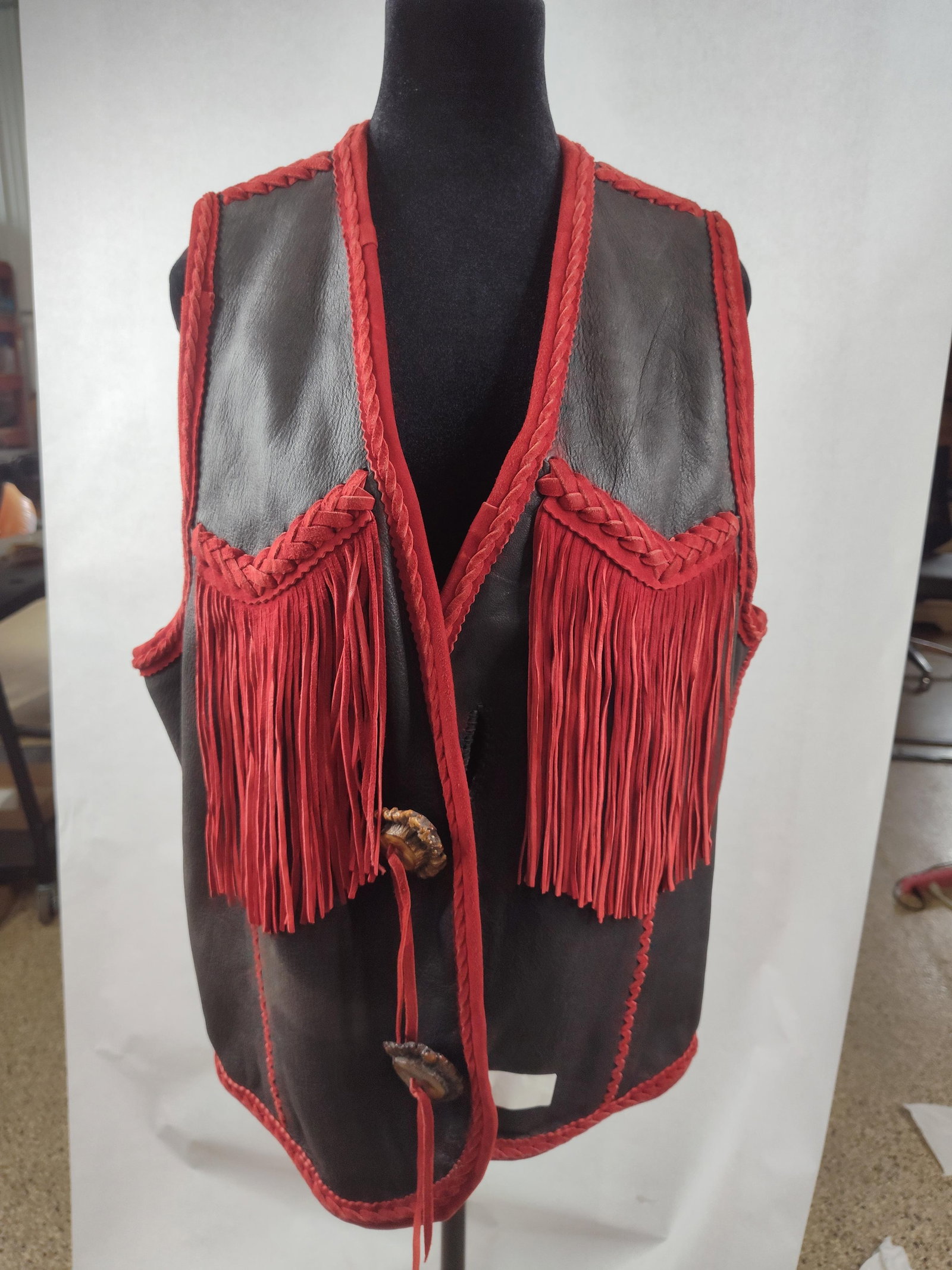 Vtg Western Leather & Suede Fringe Vest: This Western-style vest is constructed from black grain leather with contrasting red suede embellishments. The garment features a deep V-neckline and an open front design. Extensive red suede