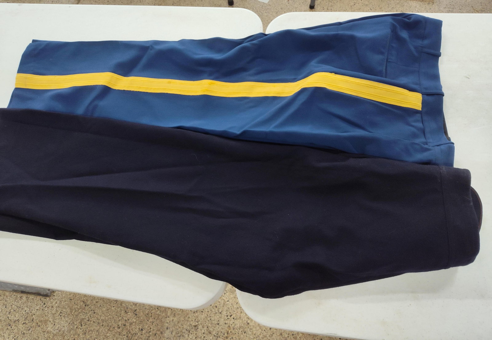 2 Pairs US Army & Navy Dress Trousers: This lot contains two pairs of United States military dress trousers consisting of one pair of US Army Army Service Uniform (ASU) trousers and one pair of US Navy enlisted dress blue trousers. The US