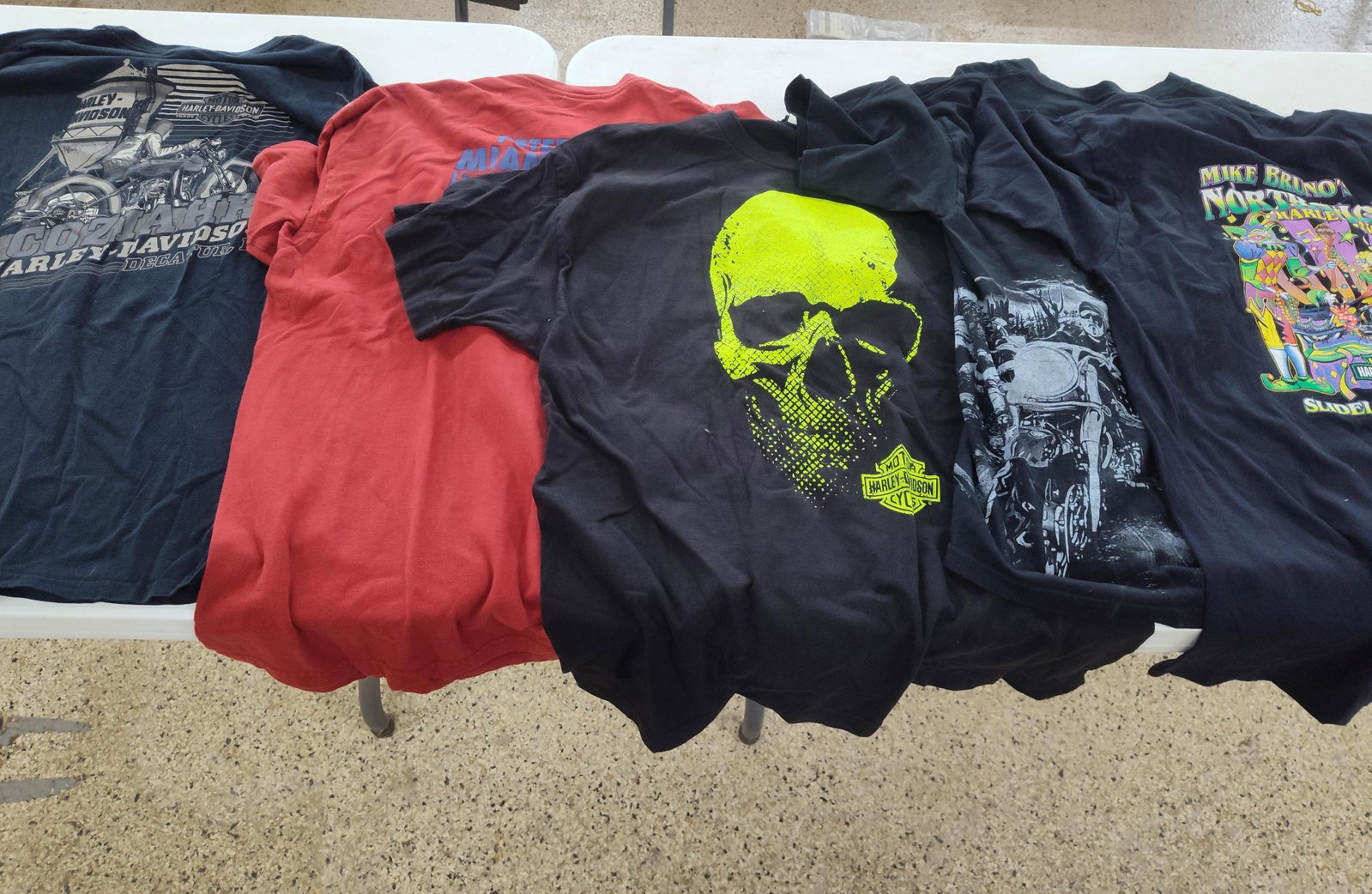 5 Harley-Davidson Dealer & Event Shirts: A collection of five contemporary Harley-Davidson themed graphic garments. The lot includes a dark navy blue long-sleeve t-shirt manufactured by RK Stratman, Inc., featuring grayscale motorcycle graph