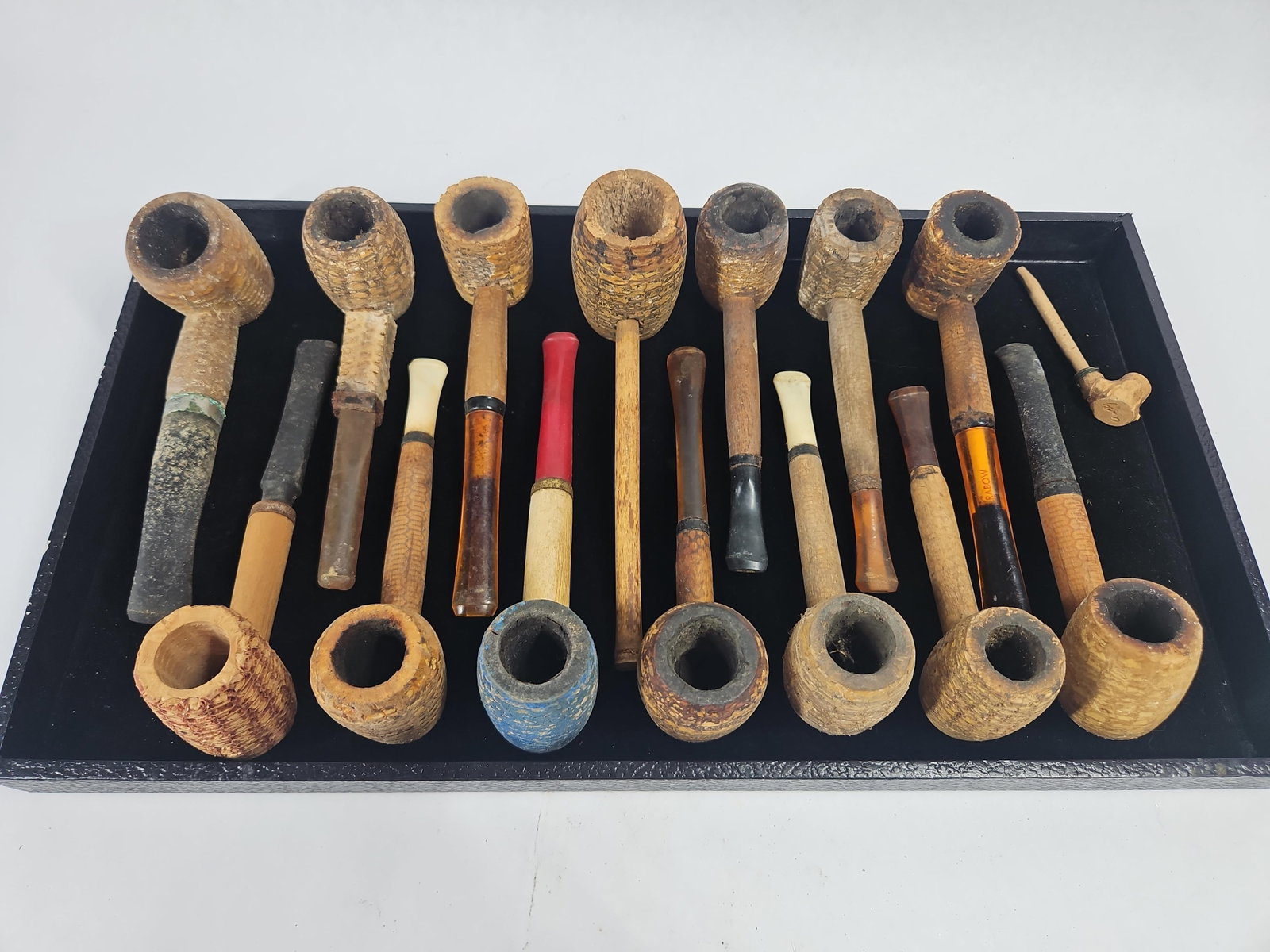 Dr. Grabow & Vtg Corn Cob Tobacco Pipes: An assortment of vintage corn cob tobacco pipes featuring bowls constructed from dried corn cob. The collection showcases a variety of bowl shapes, including cylindrical and barrel forms, with wooden