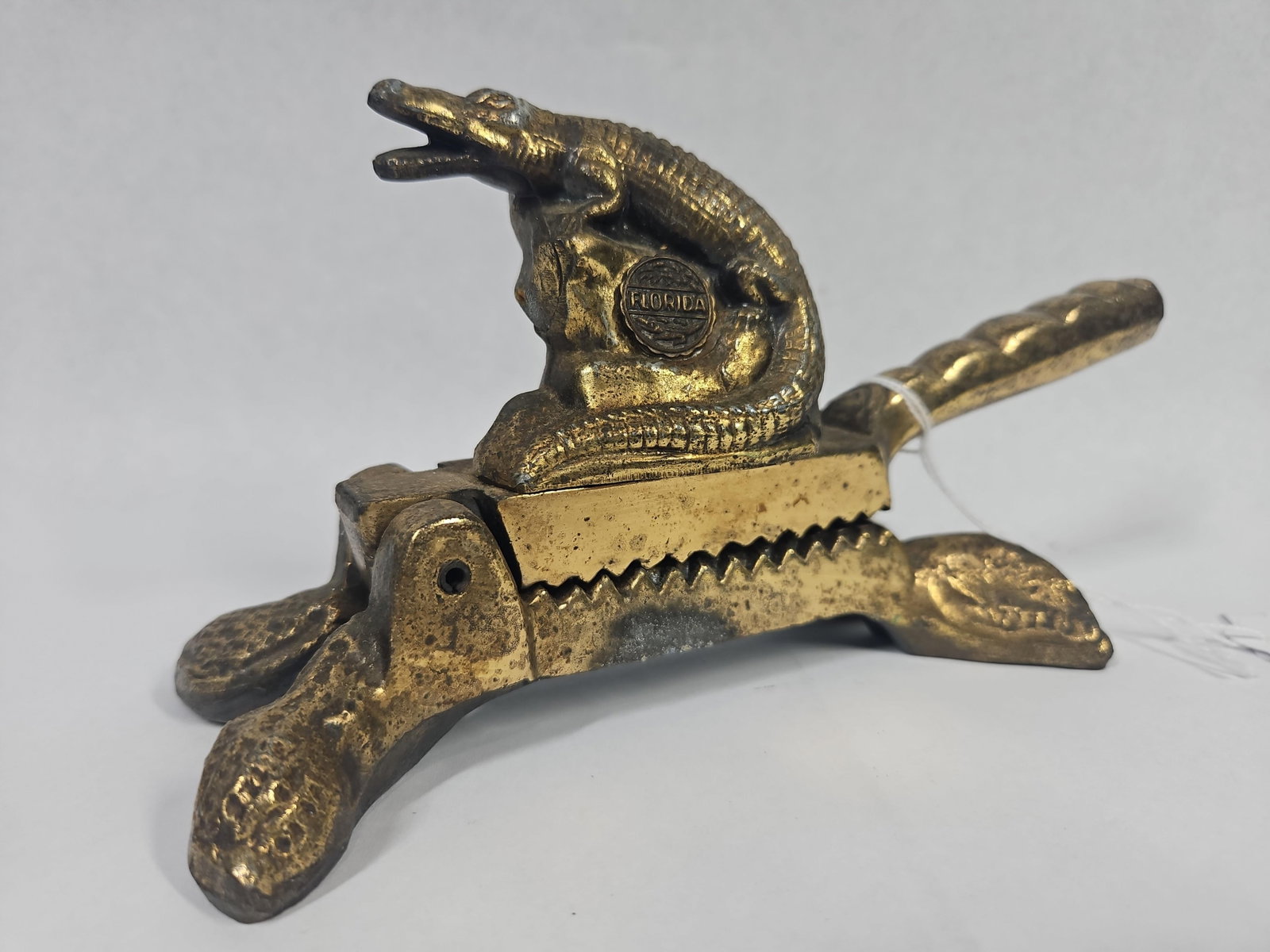 Vtg American Metal Alligator Nutcracker: A vintage American-made lever-action nutcracker featuring a figural alligator subject. The piece is constructed from cast white metal with an applied brass-toned finish. The upper lever is modeled as