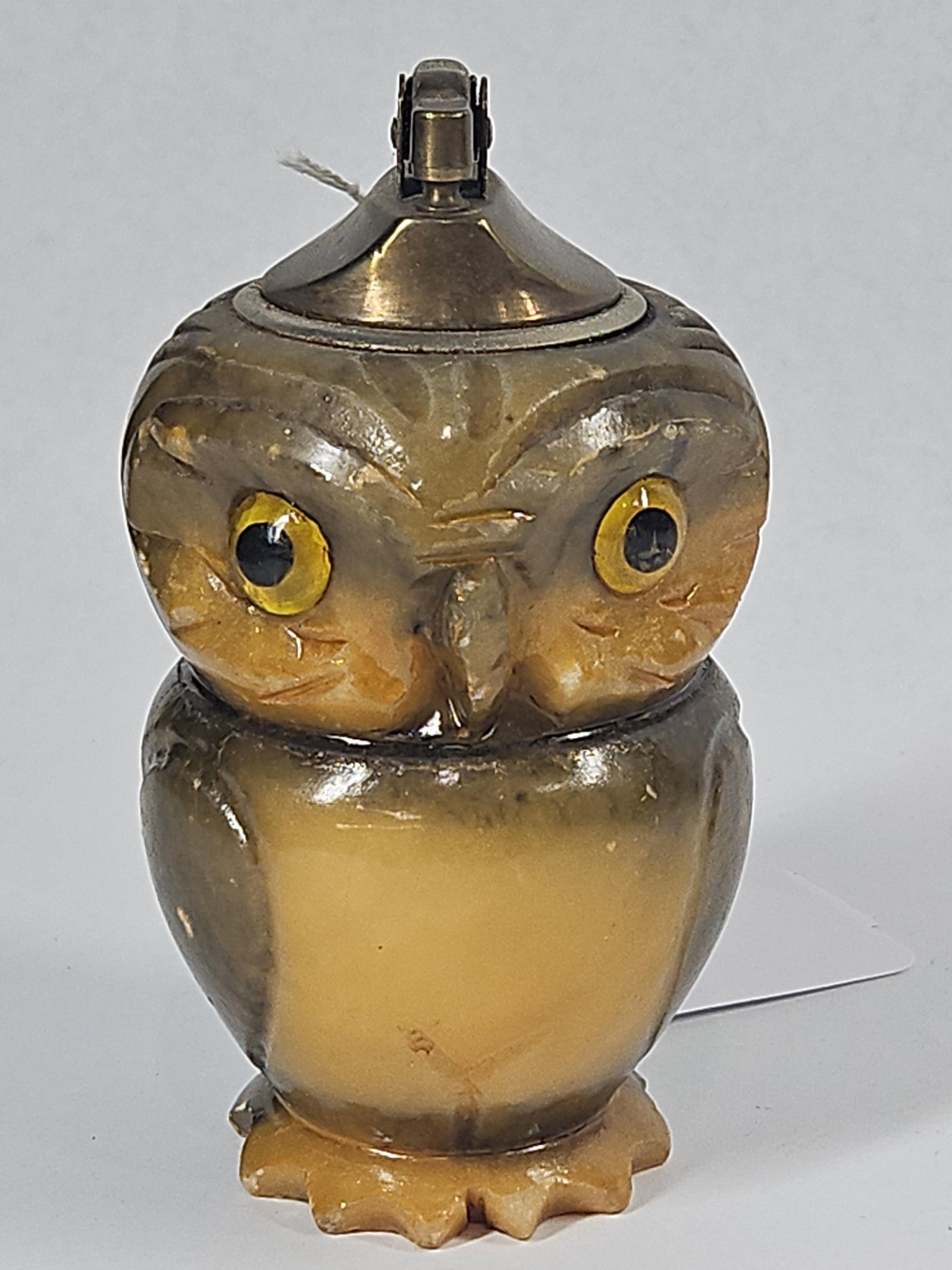 Italian Alabaster Owl Table Lighter: An Italian hand-carved alabaster table lighter fashioned in the form of an owl. The sculpture consists of a two-part stacked stone body with carved textural incisions representing plumage and wings.