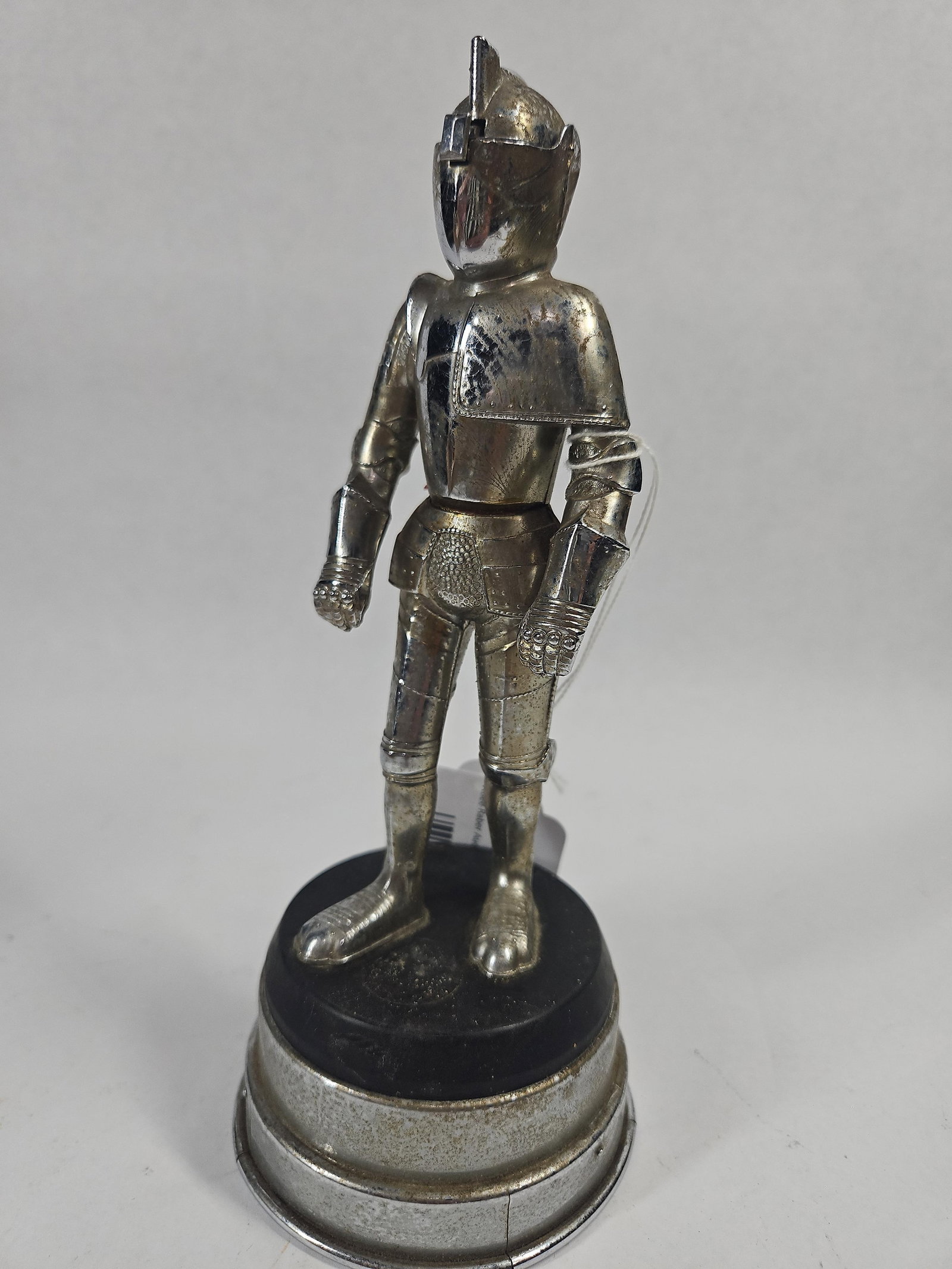 Mid-20th C. Chrome Knight Armor Lighter: This is a mid-20th-century mechanical novelty table lighter and music box designed in the form of a standing knight in full Renaissance-style plate armor. The figurine is constructed from chrome-plate